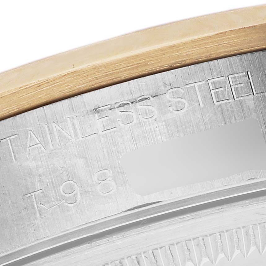The image shows a close-up of the case back edge for a Rolex Date 15203 Men's Steel and Gold (two tone) Silver Dial 15203 Men's Steel and Gold (two tone) Silver Dial model, highlighting the stainless steel engraving.
