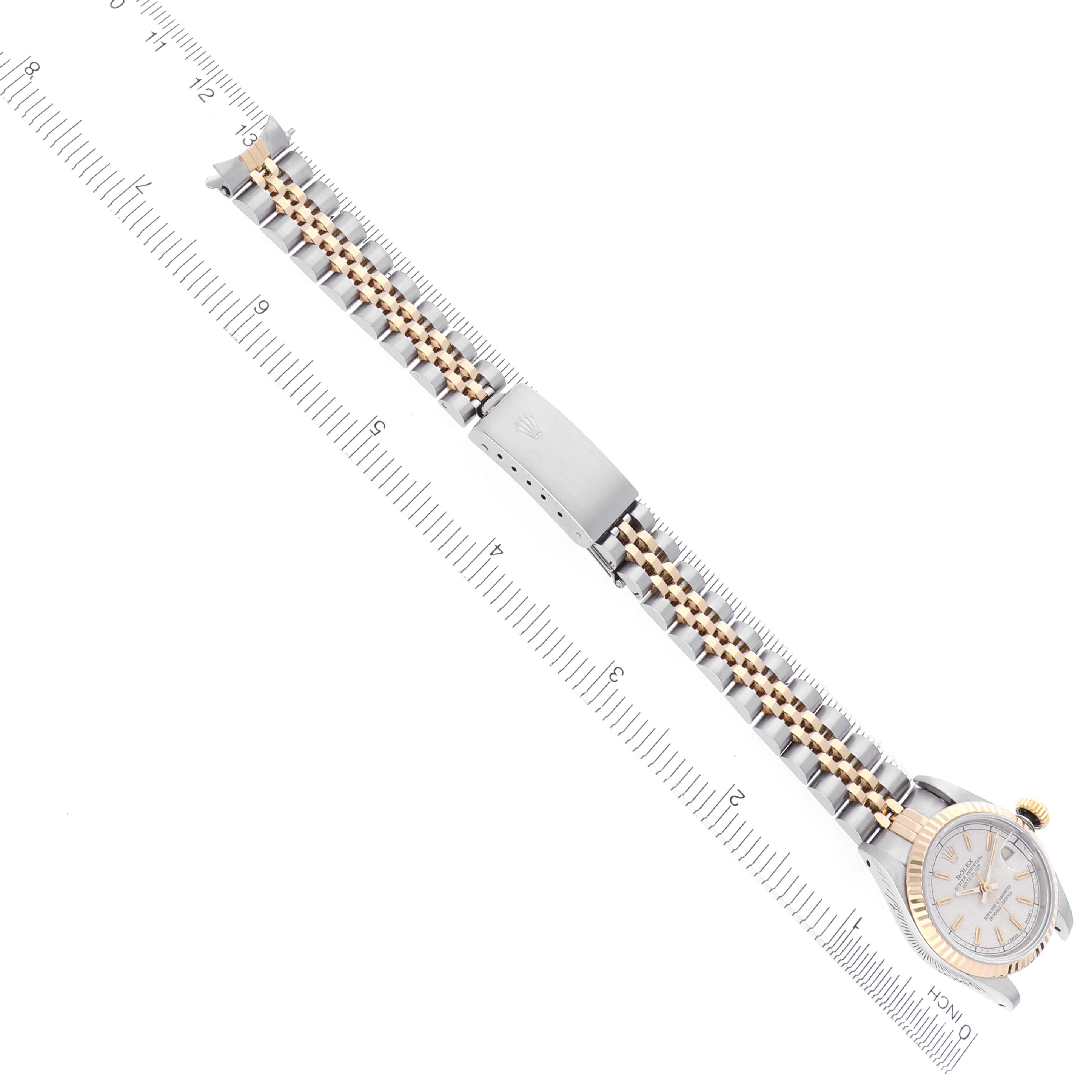 The image shows a Rolex Datejust 69173 Women's Steel and Gold (two tone) White Dial 69173 Women's Steel and Gold (two tone) White Dial watch facing down with the bracelet and clasp fully extended along a ruler.