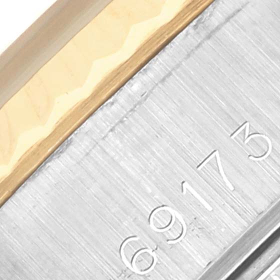 This image shows a close-up of the side of a Rolex Datejust 69173 Women's Steel and Gold (two tone) White Dial 69173 Women's Steel and Gold (two tone) White Dial model's metal bracelet, highlighting its serial number.