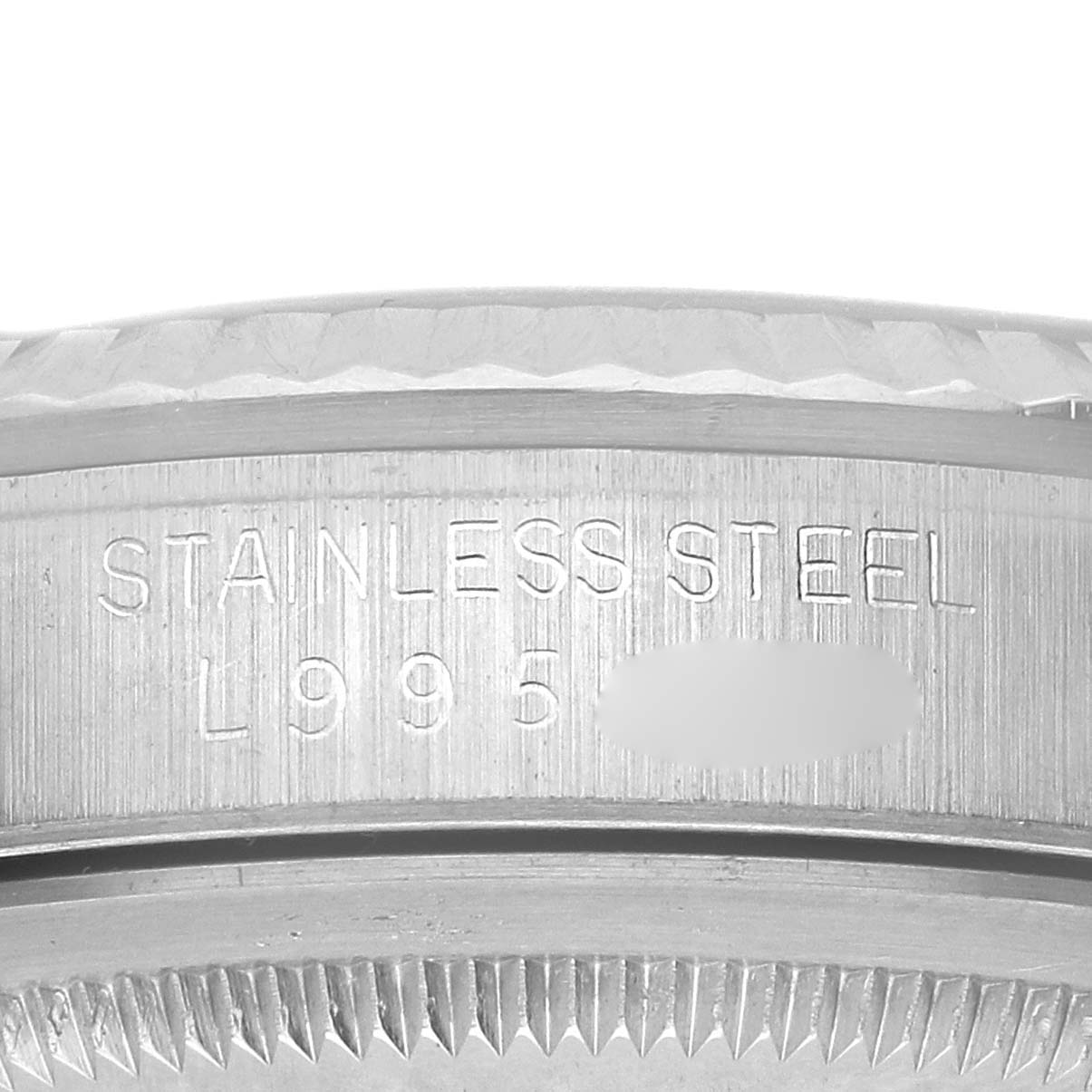 The image shows a close-up of the side of a Datejust Rolex watch, focusing on the stainless steel and engraved model details.