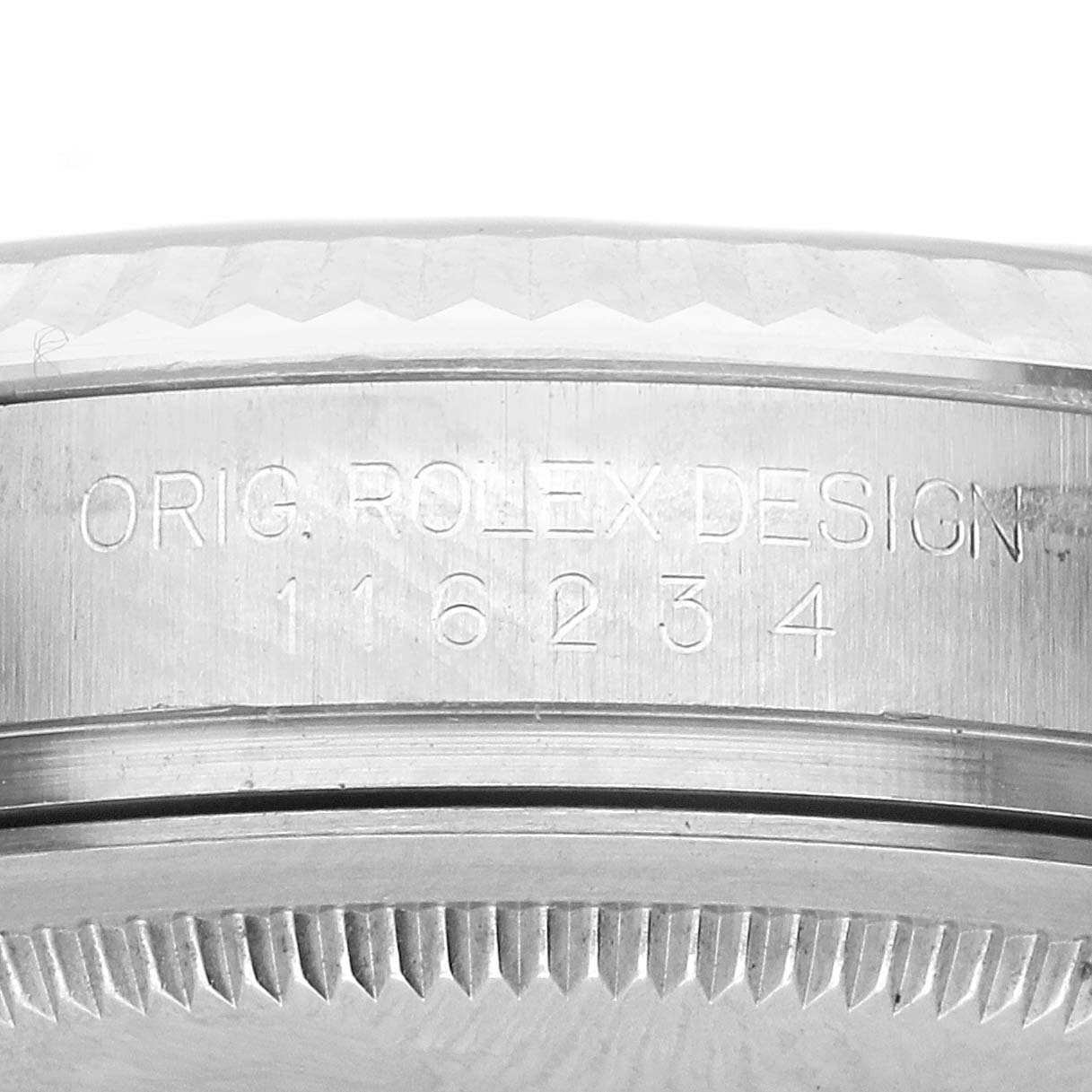The image shows a close-up of the side of a Rolex Datejust 116234 Men's Stainless Steel White Dial 116234 Men's Stainless Steel White Dial, highlighting the engraved serial number and part of the bezel.