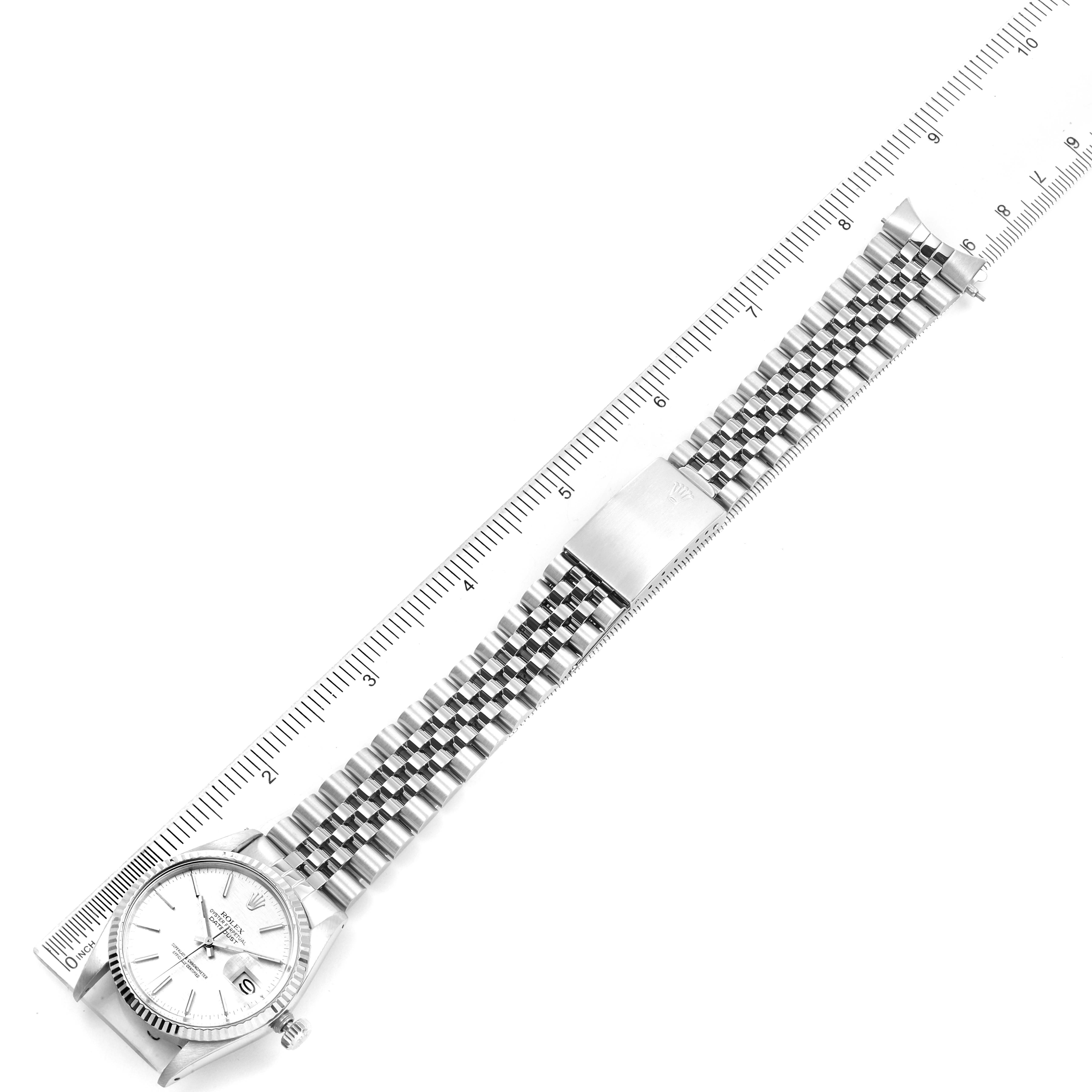 The image shows a top-down view of a Rolex Vintage Collection 16014 Men's Stainless Steel Silver Dial 16014 Men's Stainless Steel Silver Dial model watch with its band and face visible next to a ruler.