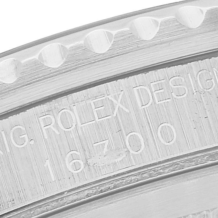 This close-up image shows the engraved serial number and part of the bezel of the Rolex GMT-Master 16700 Men's Stainless Steel Black Dial 16700 Men's Stainless Steel Black Dial model 16700.
