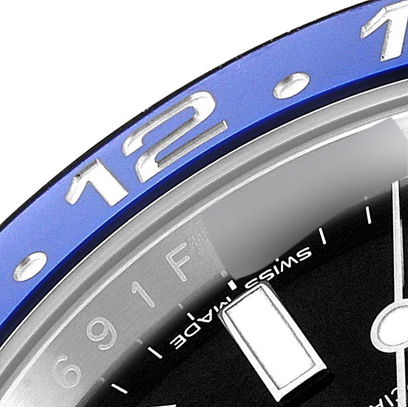 This image shows a close-up of the bezel and part of the dial of the Rolex GMT-Master 116710 Men's Stainless Steel Black Dial 116710 Men's Stainless Steel Black Dial watch.
