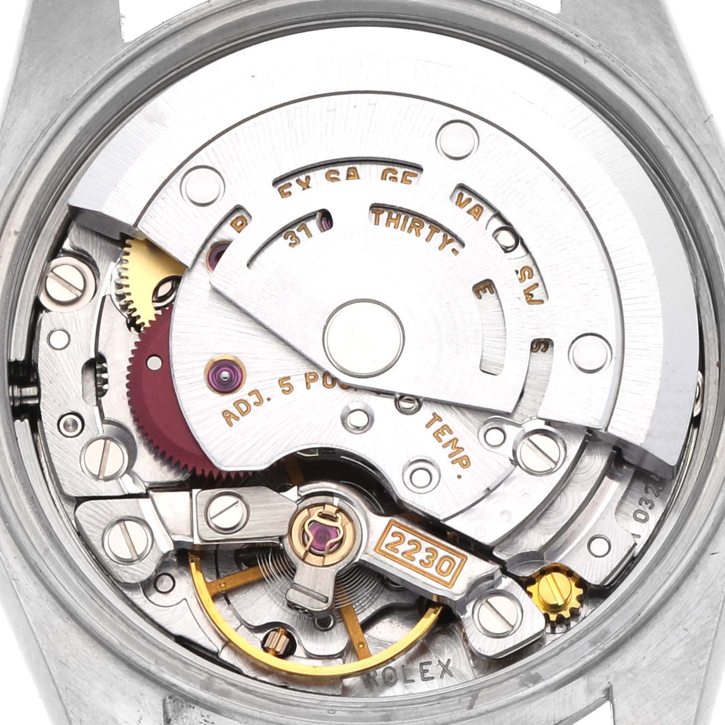 The image shows the movement of a Rolex Oyster Perpetual 76030 Women's Stainless Steel Black Dial 76030 Women's Stainless Steel Black Dial watch from the back, highlighting the rotor, gears, and balance wheel.