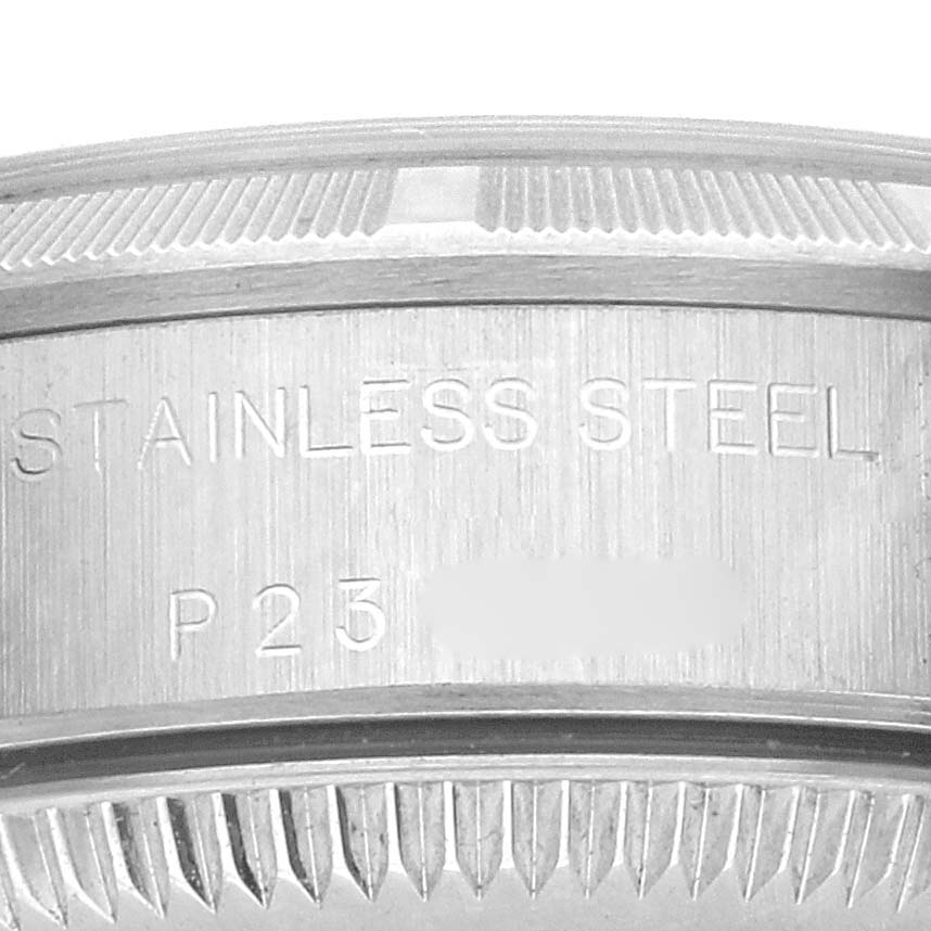 The image shows a close-up of the Rolex Oyster Perpetual 76030 Women's Stainless Steel Black Dial 76030 Women's Stainless Steel Black Dial's stainless steel case back with engraving detail.