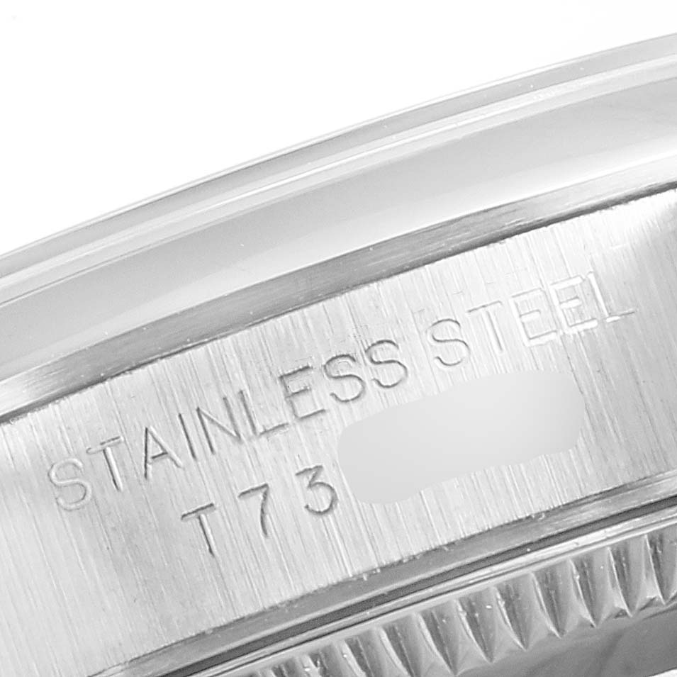 This close-up image shows the stainless steel case edge and markings of a Rolex Oyster Perpetual 67180 Women's Stainless Steel White Dial 67180 Women's Stainless Steel White Dial watch.