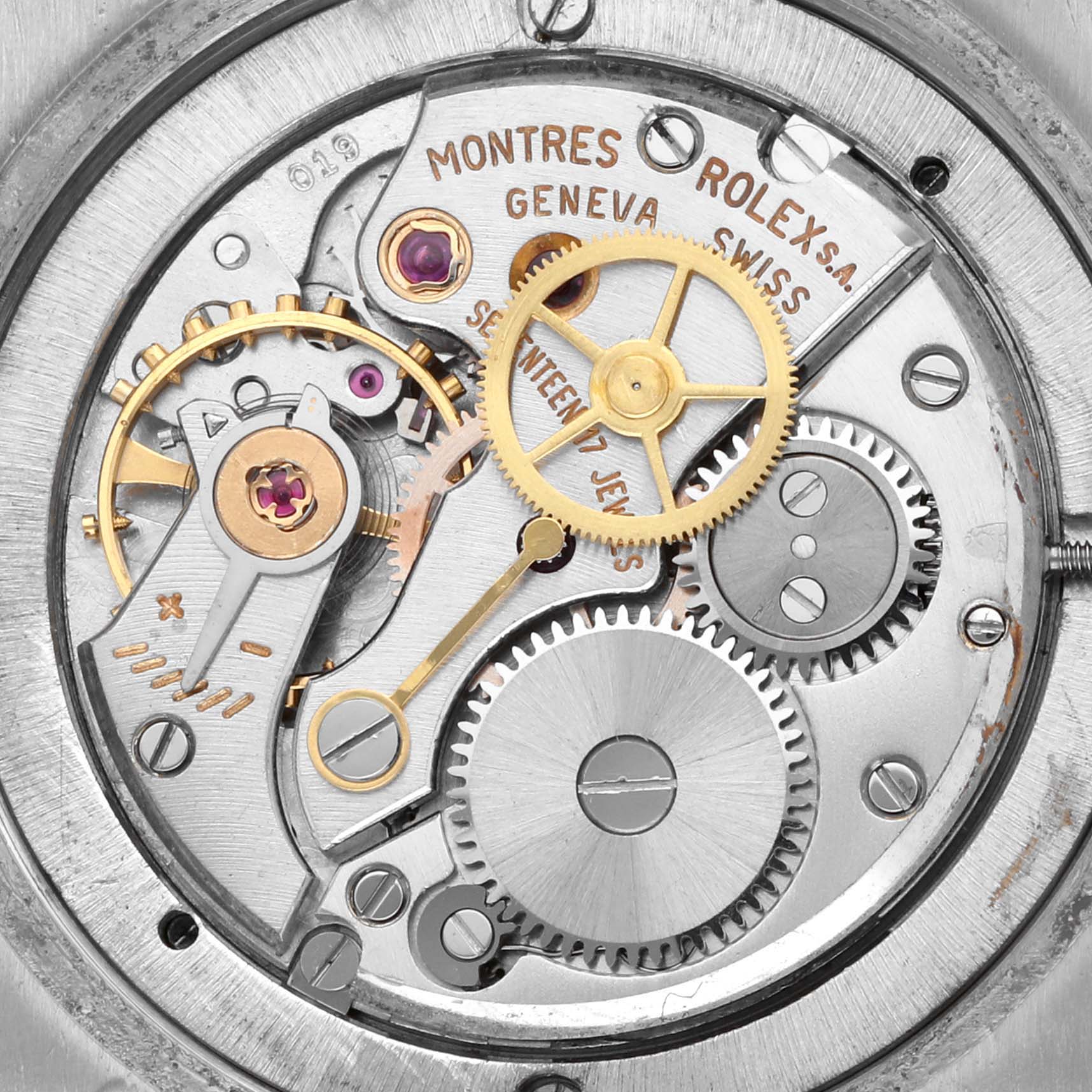 The image shows a close-up of the movement mechanism of a Rolex Date 6694 Men's Stainless Steel Black Dial 6694 Men's Stainless Steel Black Dial model watch, featuring gears and jewels.