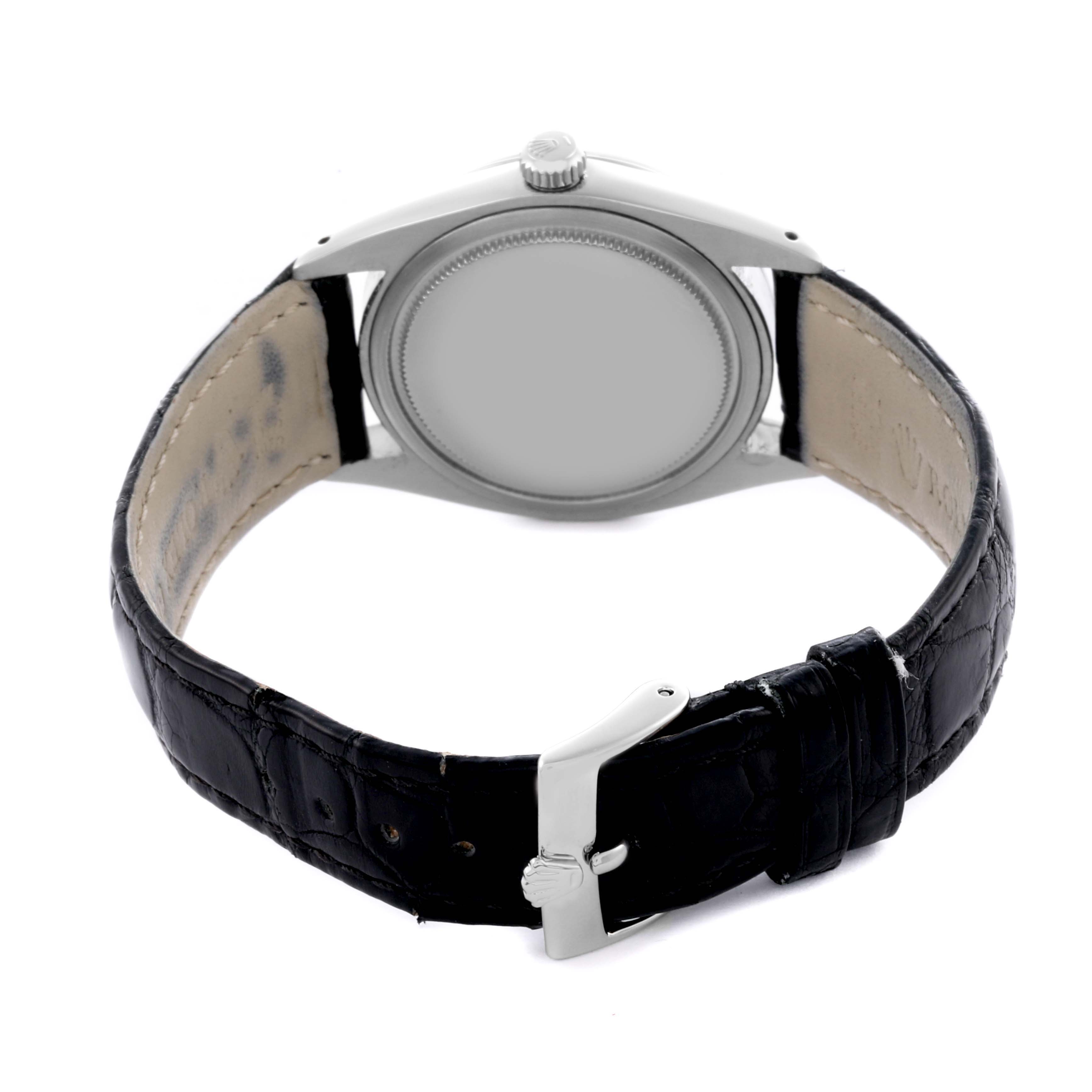 The image shows the backside of a Rolex Date 6694 Men's Stainless Steel Black Dial 6694 Men's Stainless Steel Black Dial model watch with a leather strap, showcasing the case back and buckle.