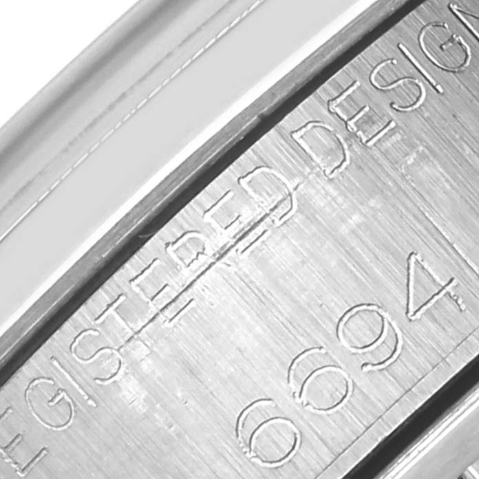 The image shows a close-up of the Rolex Date 6694 Men's Stainless Steel Silver Dial 6694 Men's Stainless Steel Silver Dial model's inner case side, displaying engravings.