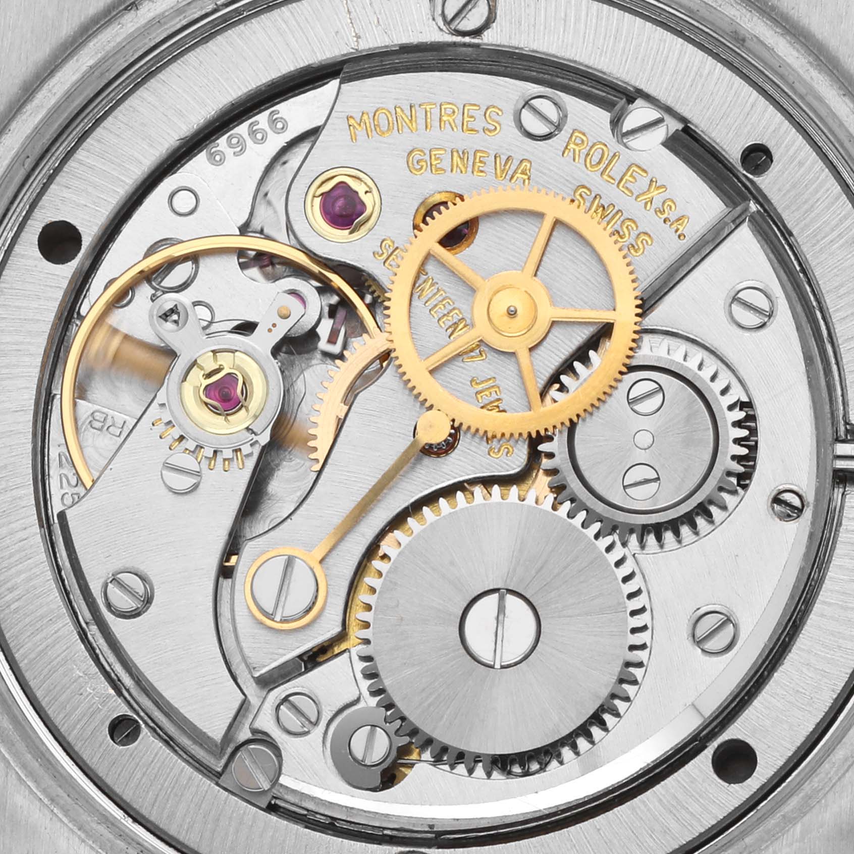 The image shows the intricate movement and gears of a Rolex Date 6694 Men's Stainless Steel Silver Dial 6694 Men's Stainless Steel Silver Dial model watch, viewed from the back.