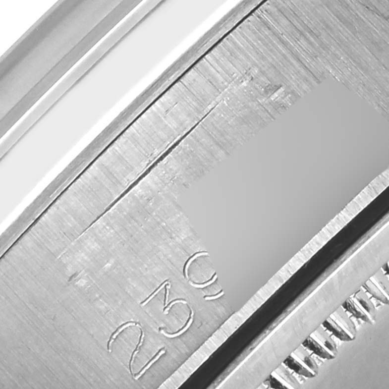 The image shows a close-up angle of the serial number engraving on a Rolex Date 6694 Men's Stainless Steel Silver Dial 6694 Men's Stainless Steel Silver Dial model watch.