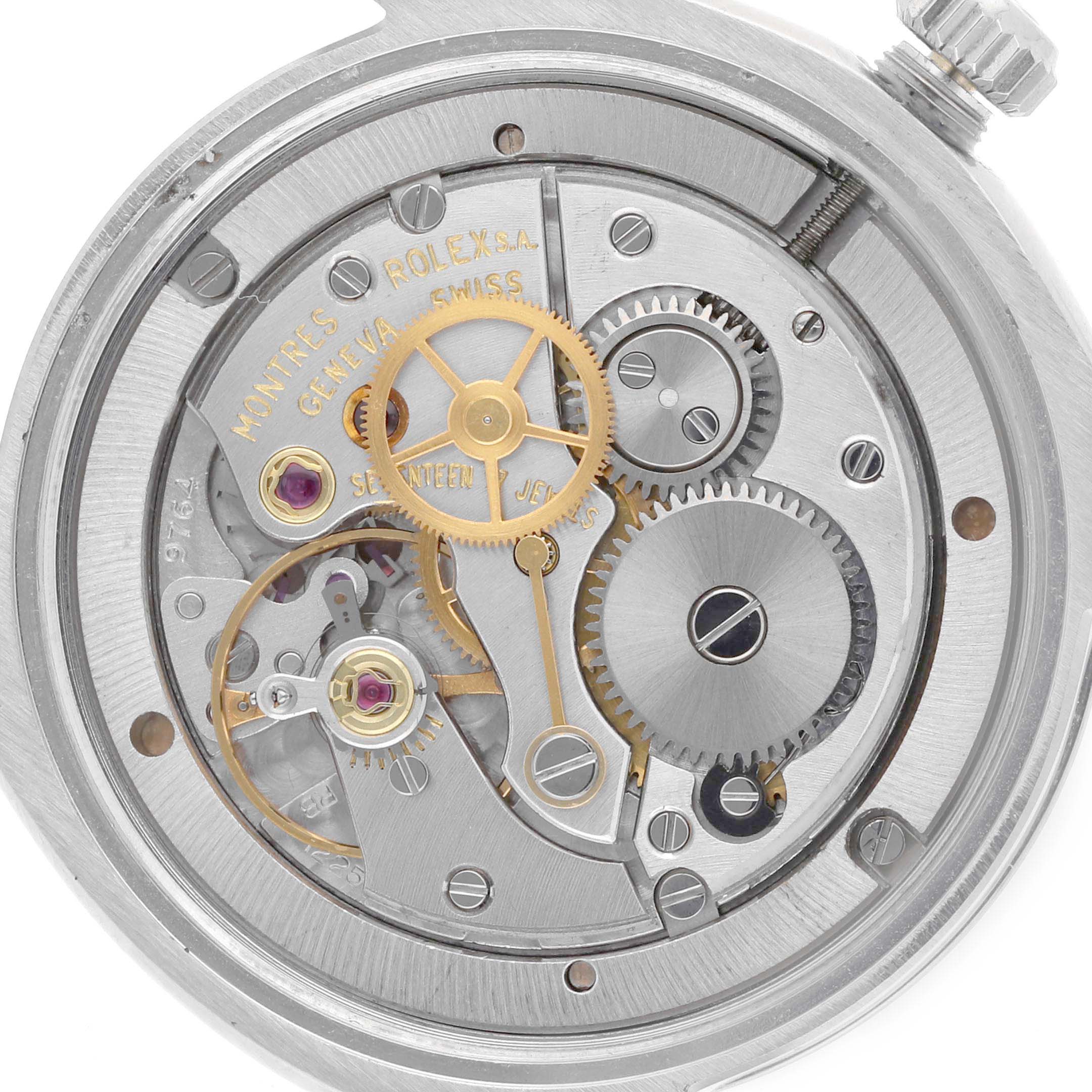 The image shows the movement of a Rolex Date 6694 Men's Stainless Steel Silver Dial 6694 Men's Stainless Steel Silver Dial model watch from a top-down angle, highlighting the gears and inner components.