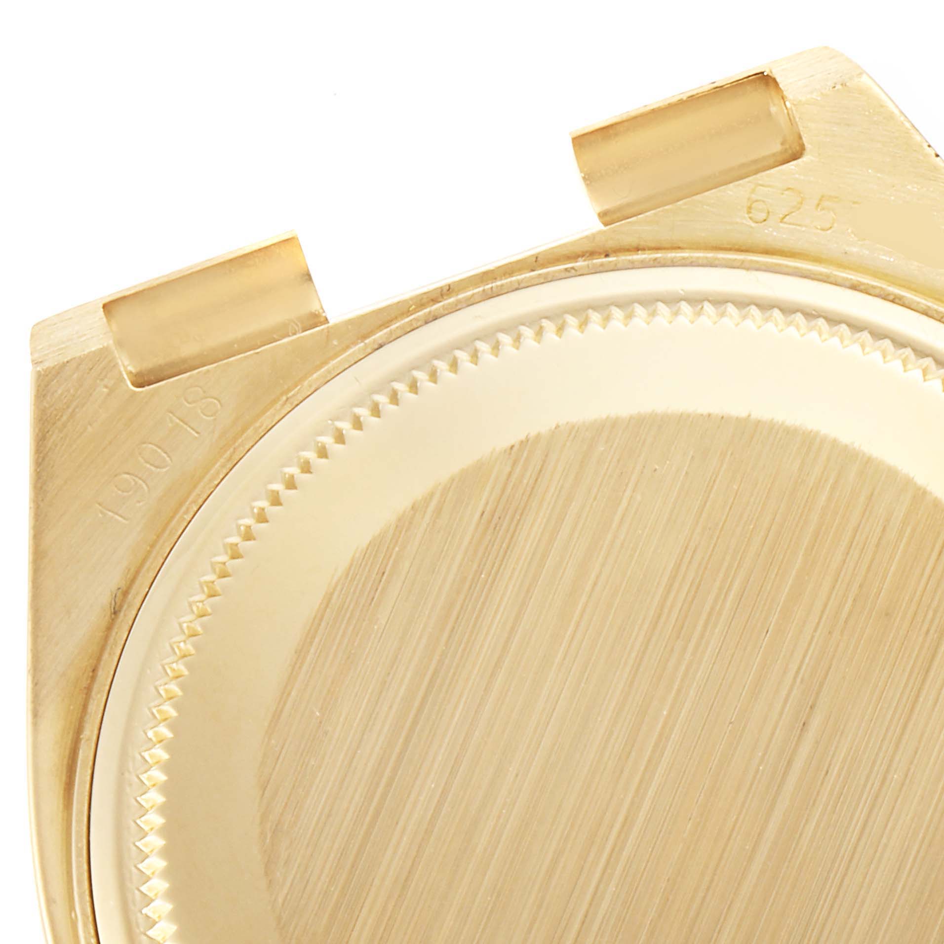 This image shows a close-up, top-down angle of the gold case back of a Rolex Oysterquartz 19018 Men's Yellow Gold Champagne Dial 19018 Men's Yellow Gold Champagne Dial watch.