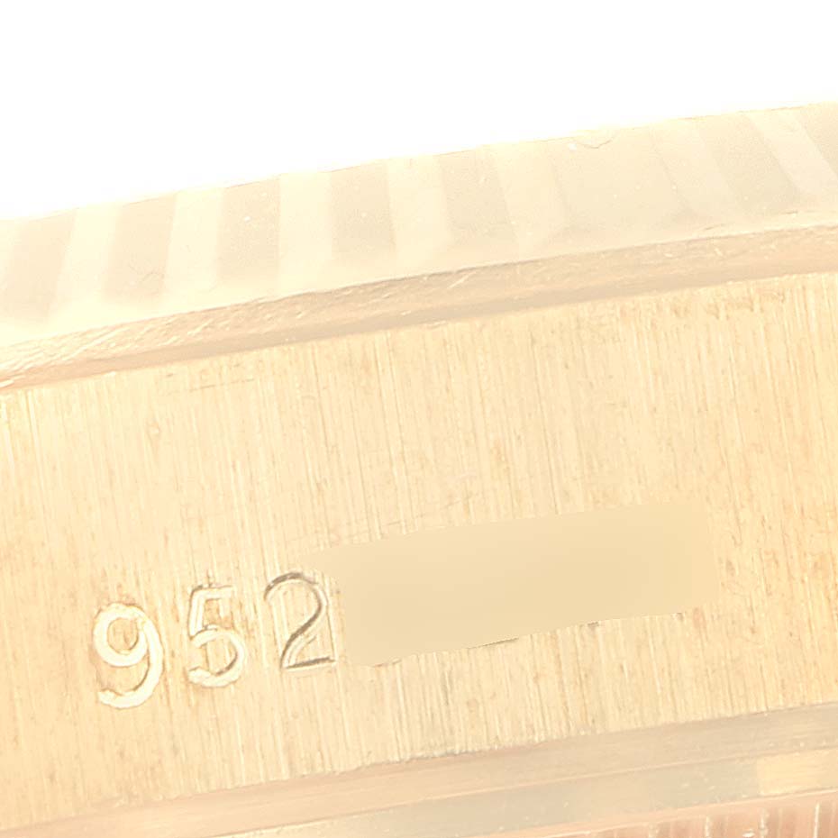 The image shows a close-up of the case side of a Rolex President 69178 Women's Yellow Gold Champagne Dial 69178 Women's Yellow Gold Champagne Dial model, featuring a fluted bezel and serial number engraving.