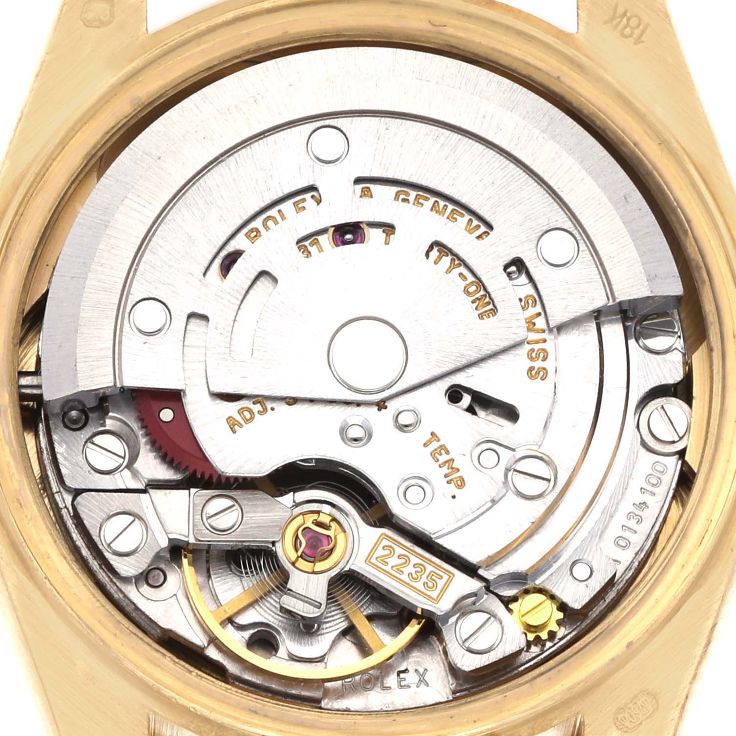 The image shows the movement mechanism of a Rolex President 79138 Women's Yellow Gold White Dial 79138 Women's Yellow Gold White Dial watch from a top-down angle, revealing gears and inscriptions.
