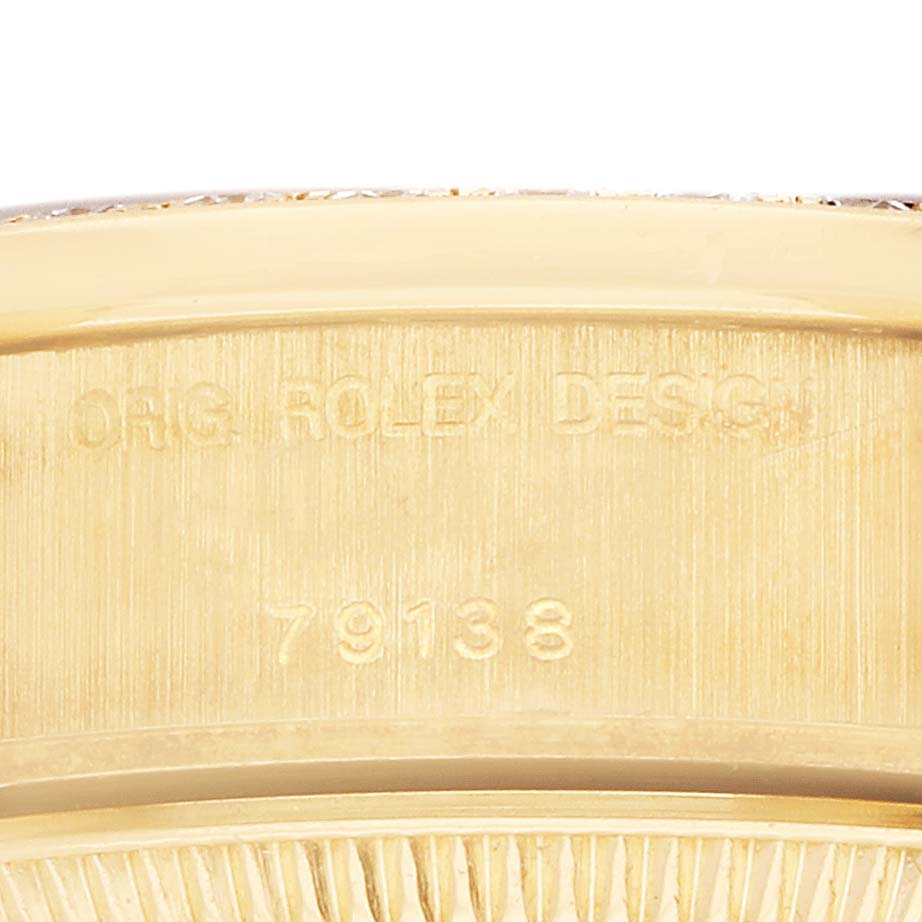 The image shows a close-up of the back case edge of a Rolex President 79138 Women's Yellow Gold White Dial 79138 Women's Yellow Gold White Dial, featuring engravings of the model number.