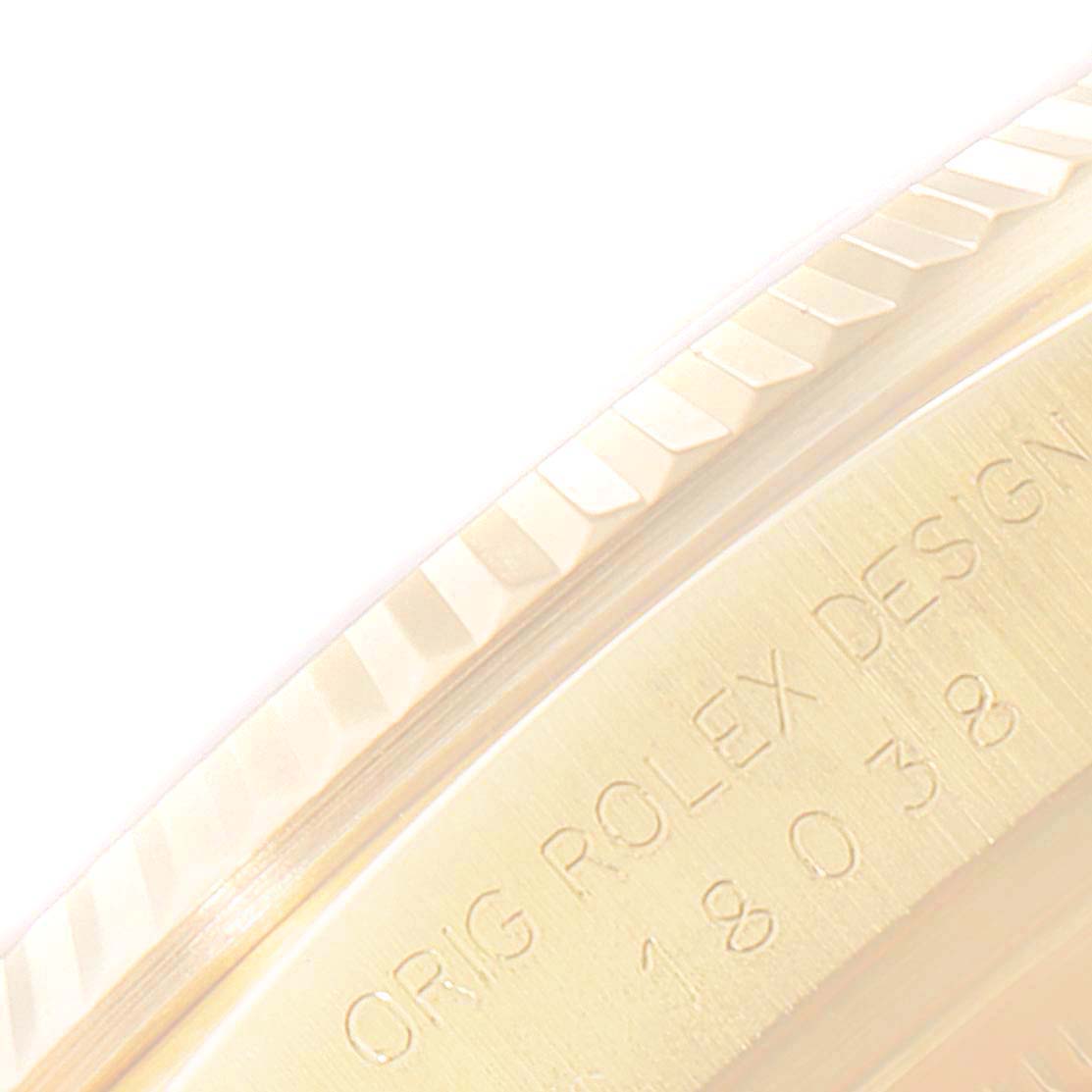 This close-up image shows the engraved case back and fluted bezel of a Rolex President 18038 Men
s Yellow Gold Champagne Dial 18038 Men
s Yellow Gold Champagne Dial model watch.