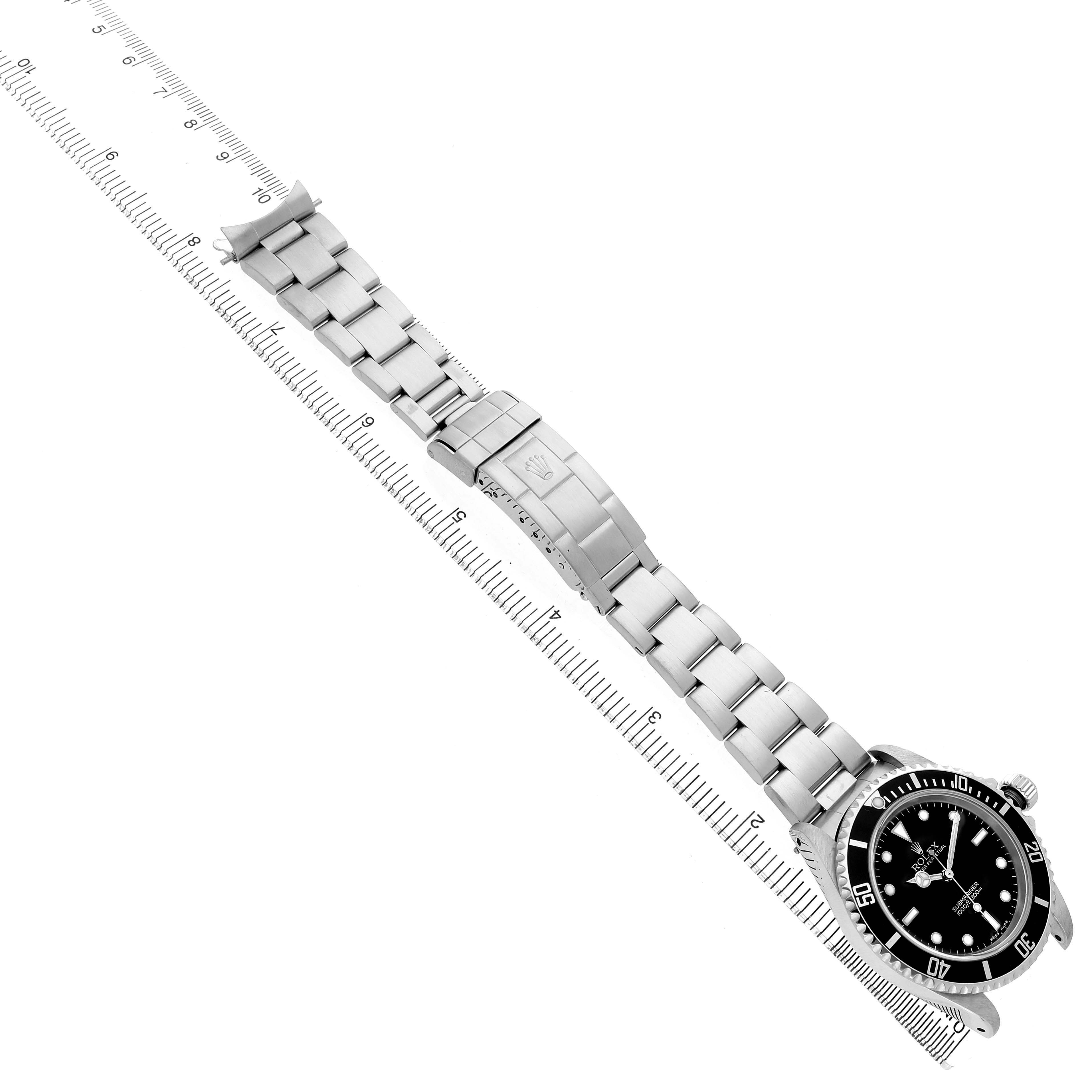 The Rolex Submariner 14060 Men's Stainless Steel Black Dial watch is shown from an overhead angle, displaying the full bracelet, clasp, and dial.