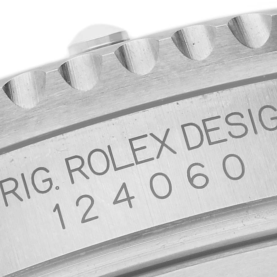 The image shows a close-up of the edge and engraved model number of the Rolex Submariner 124060 Men's Stainless Steel Black Dial 124060 Men's Stainless Steel Black Dial's case.