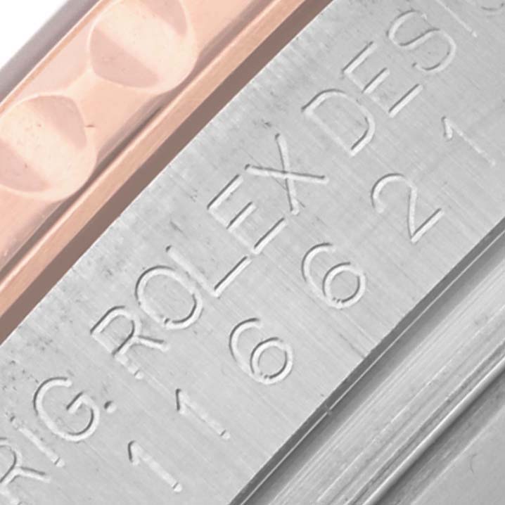 This image shows a close-up of the Rolex Yacht-Master 116621 Men's Steel and Gold (two tone) Brown Dial 116621 Men's Steel and Gold (two tone) Brown Dial's bezel and case with engraved details.