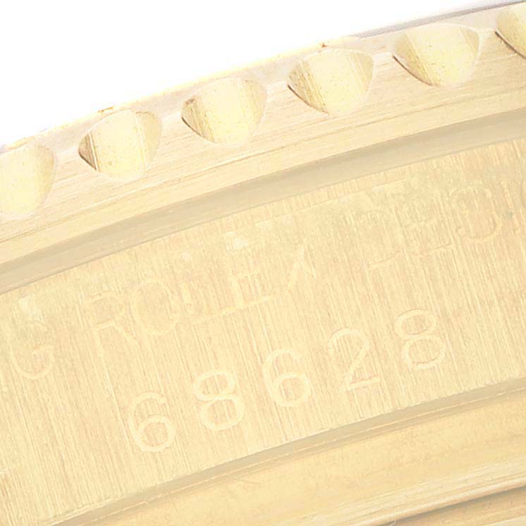 The image shows a close-up of the engraved bezel and edge, with a model number visible, of the Rolex Yacht-Master 68628 Men's Yellow Gold White Dial 68628 Men's Yellow Gold White Dial watch.