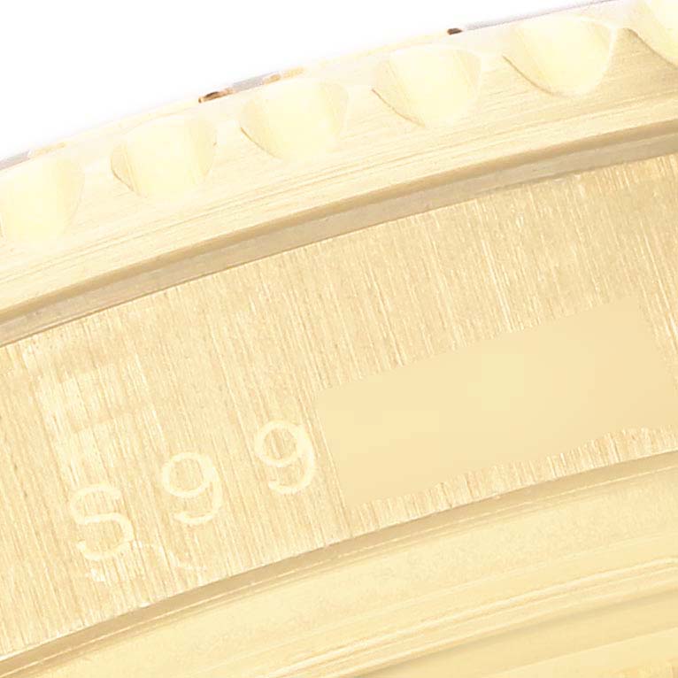 The image shows a close-up of the engraved edge of the bezel on a Rolex Yacht-Master 68628 Men's Yellow Gold White Dial 68628 Men's Yellow Gold White Dial watch.