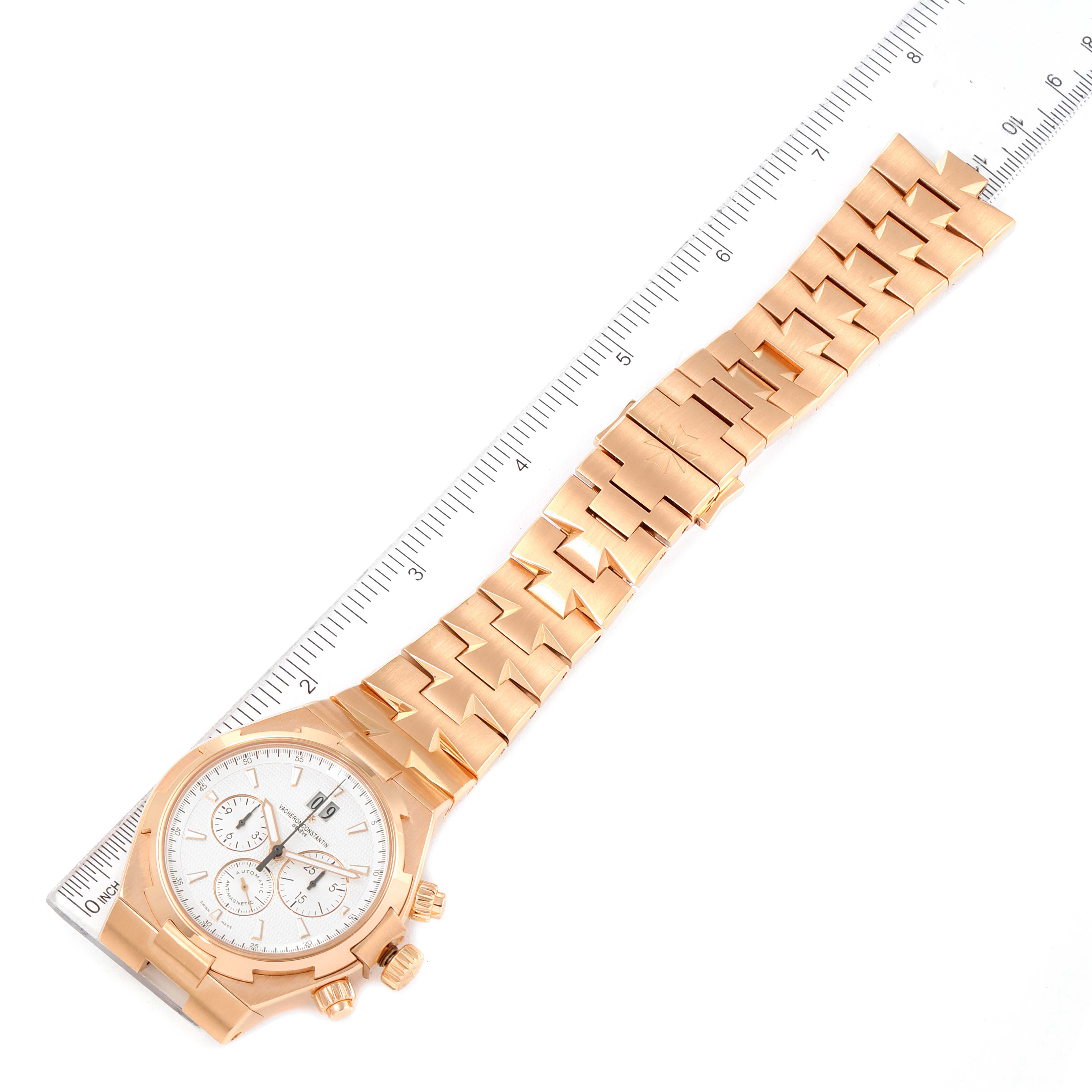 The image shows the entire Vacheron Constantin Overseas 49150/B01R-9454 Men's Rose Gold Silver Dial 49150/B01R-9454 Men's Rose Gold Silver Dial watch laid flat next to a ruler for scale.