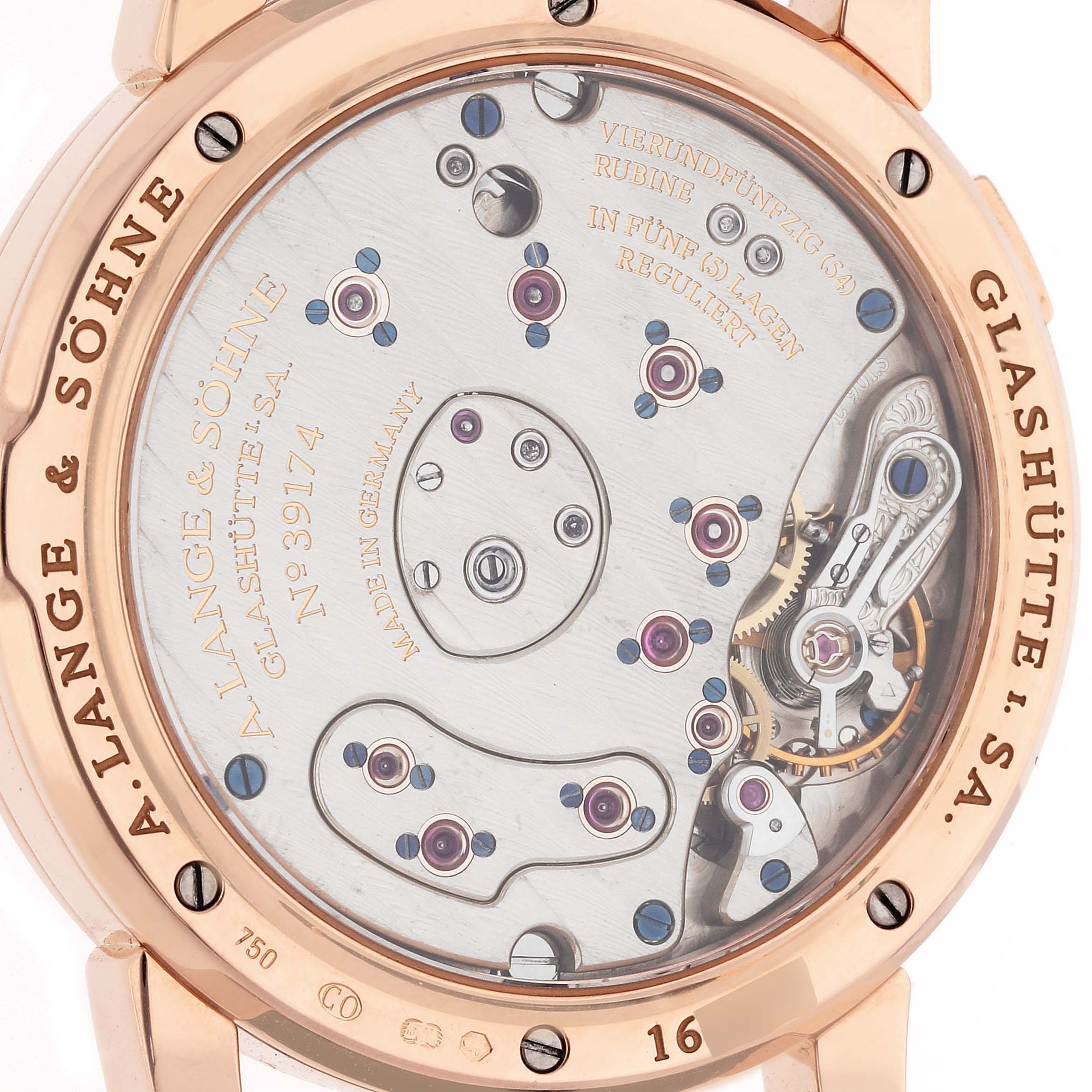 The image shows the back view of a Lange 1 watch by A. Lange & Söhne, displaying its intricate movement mechanism and engravings.