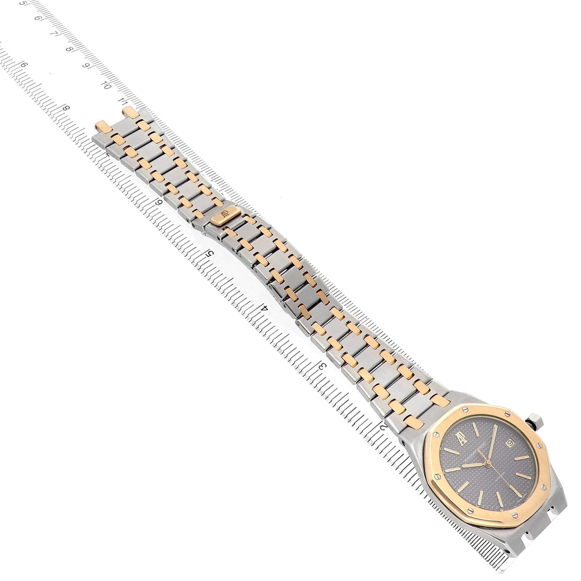 The Royal Oak by Audemars Piguet is shown from an angled top view, displaying the full bracelet and watch face with a ruler for scale.