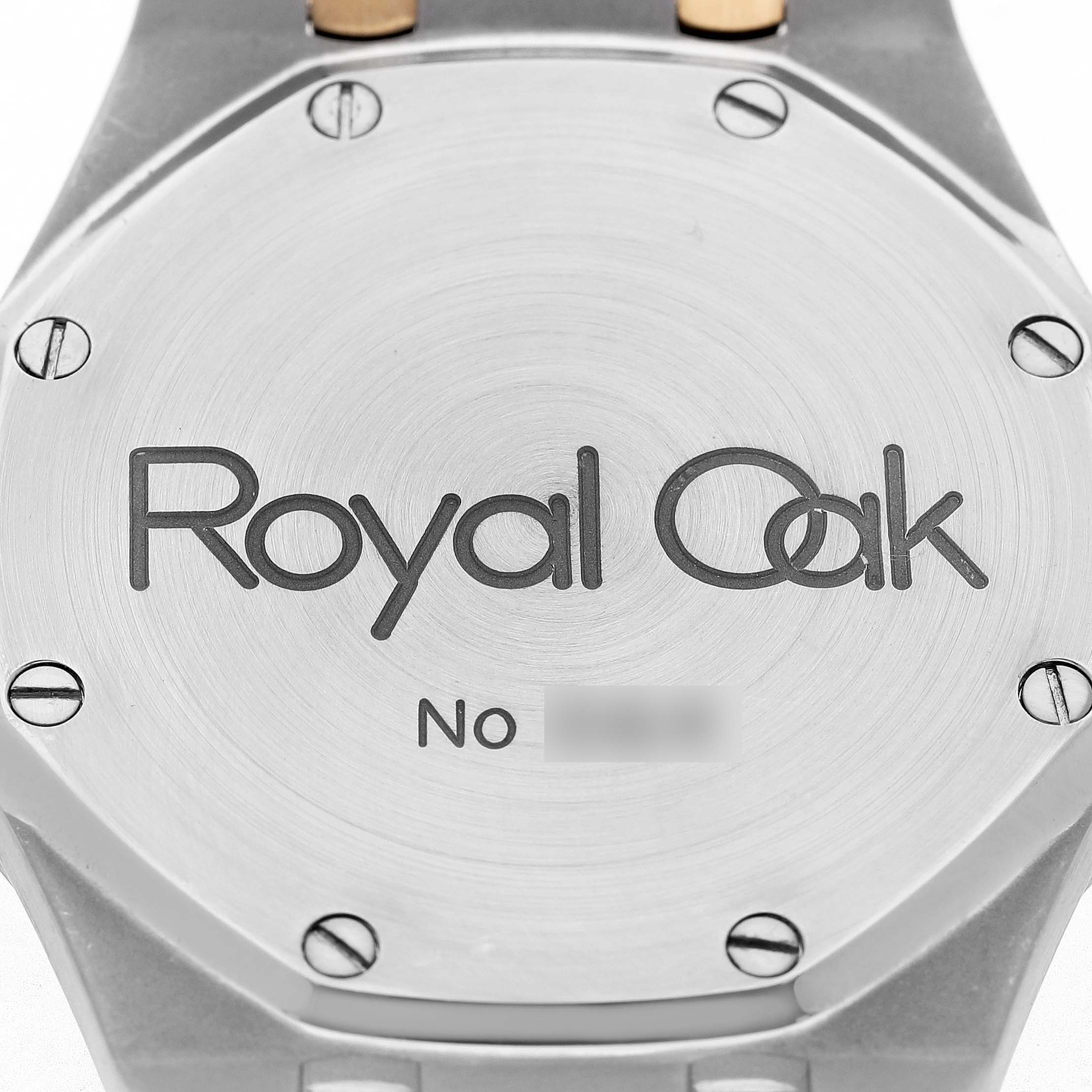 The image shows the back case of an Audemars Piguet Royal Oak 14790SA.OO.0789SA.01 Men's Steel and Gold (two tone) Grey Dial watch, featuring engraved details and visible screws.