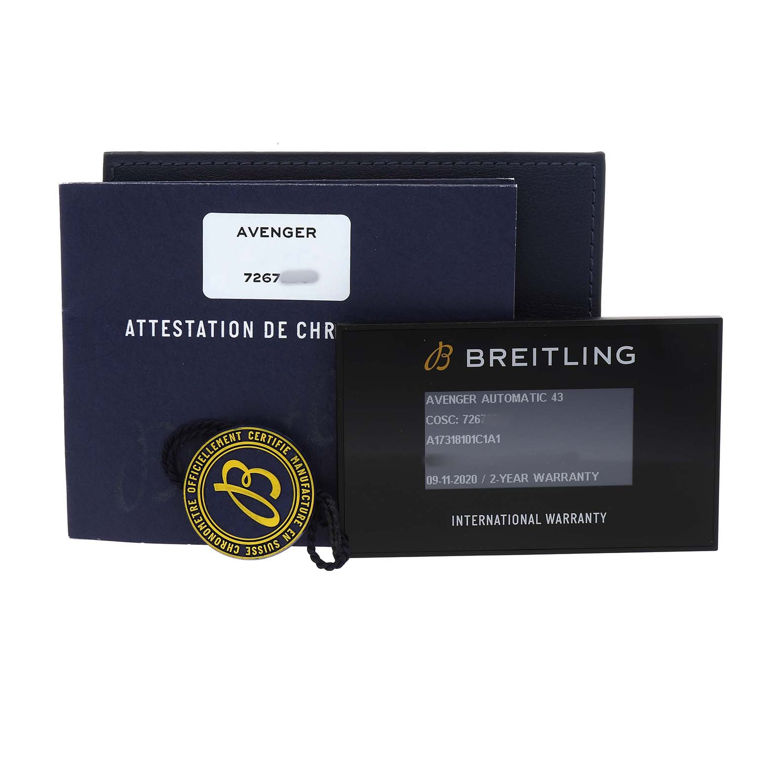 The image shows accessories for the Breitling Avenger A17318101C1A1 Men's Stainless Steel Blue Dial, including documentation, a warranty card, and a certification tag.