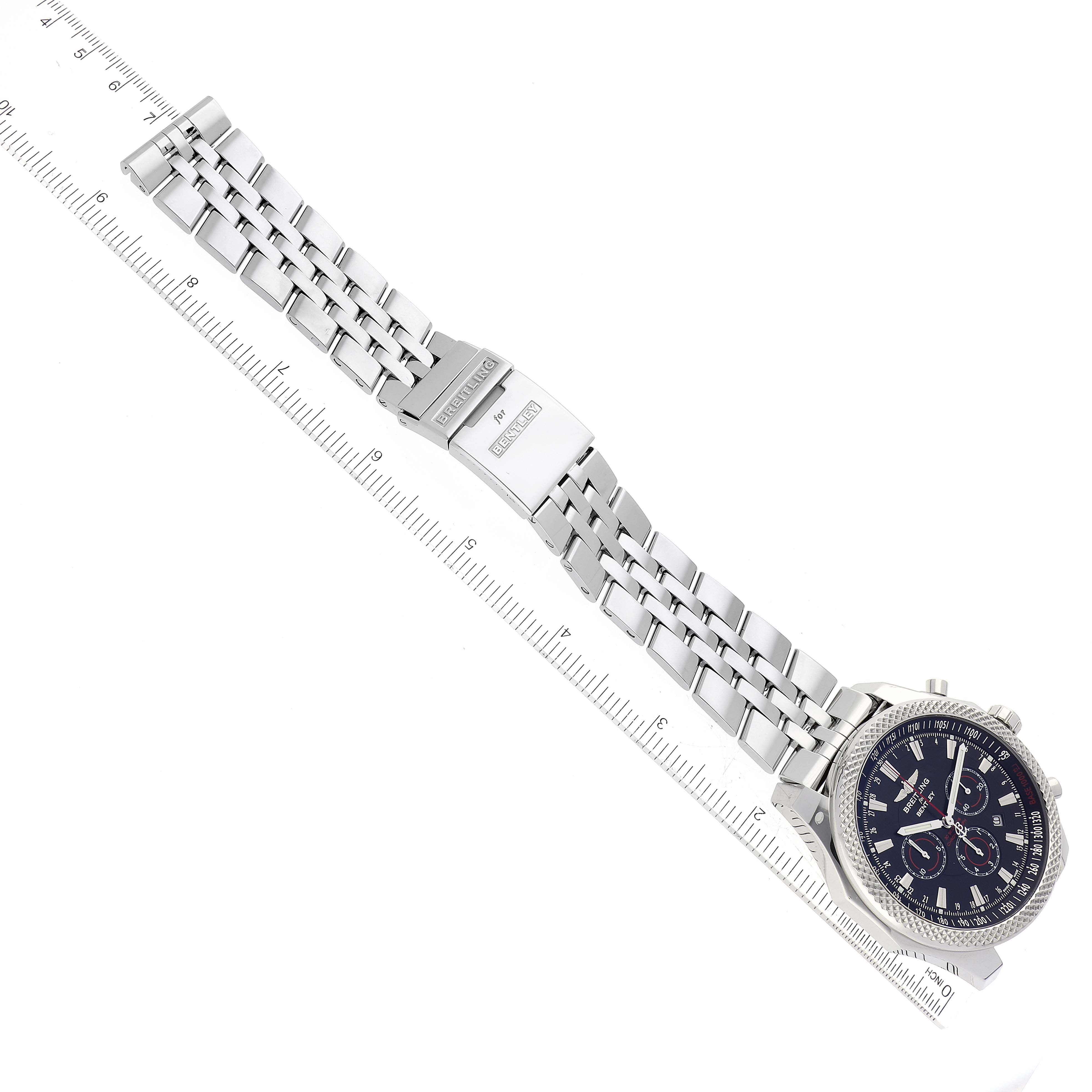 The image shows a top-down view of a Breitling Bentley A25368B11SP Men's Stainless Steel Black Dial A25368B11SP Men's Stainless Steel Black Dial watch with its full metal band and clasp extended alongside a ruler.