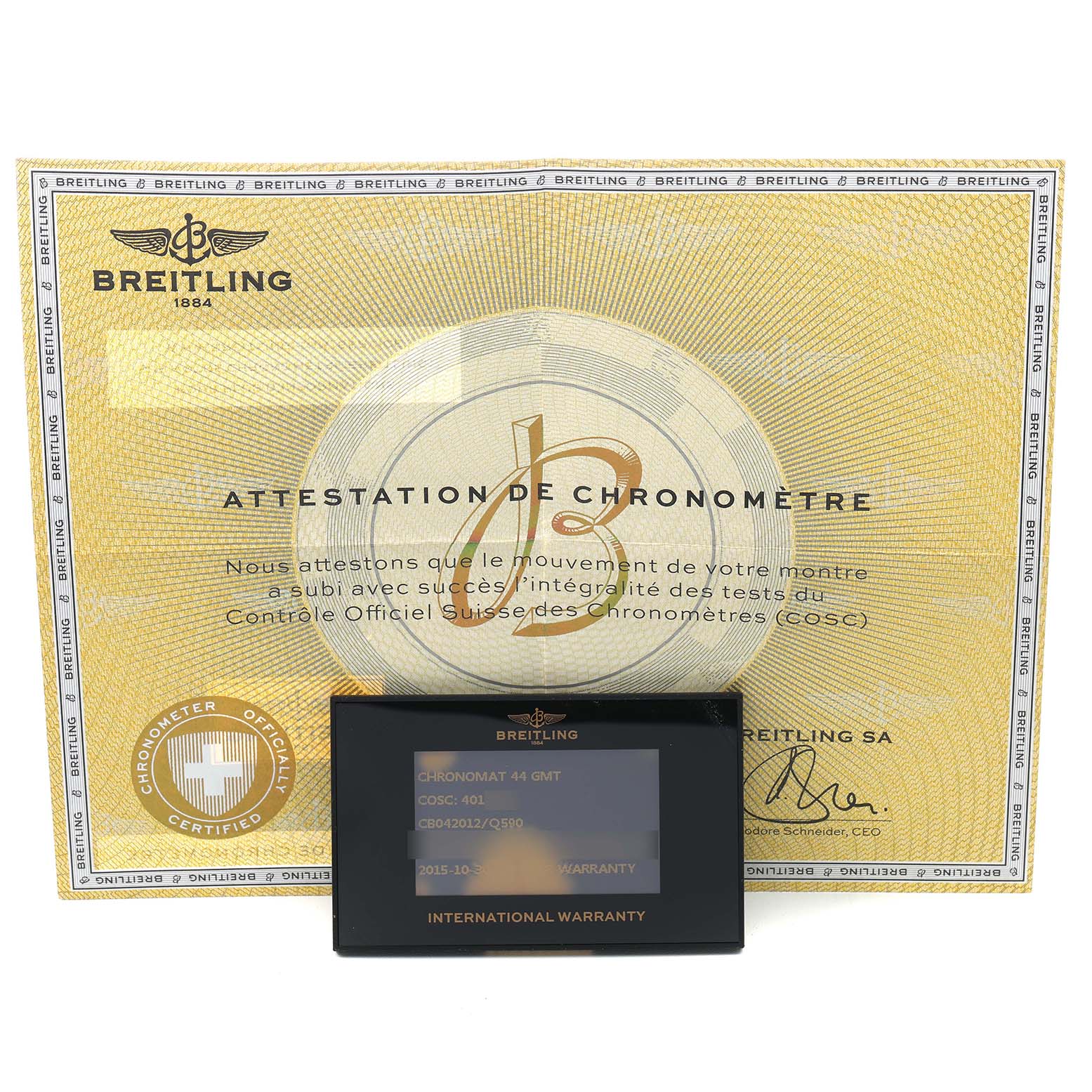 The image shows a Breitling Chronomat CB042012/Q590 Men's Stainless Steel Brown Dial warranty card and COSC certification from a top-down angle.