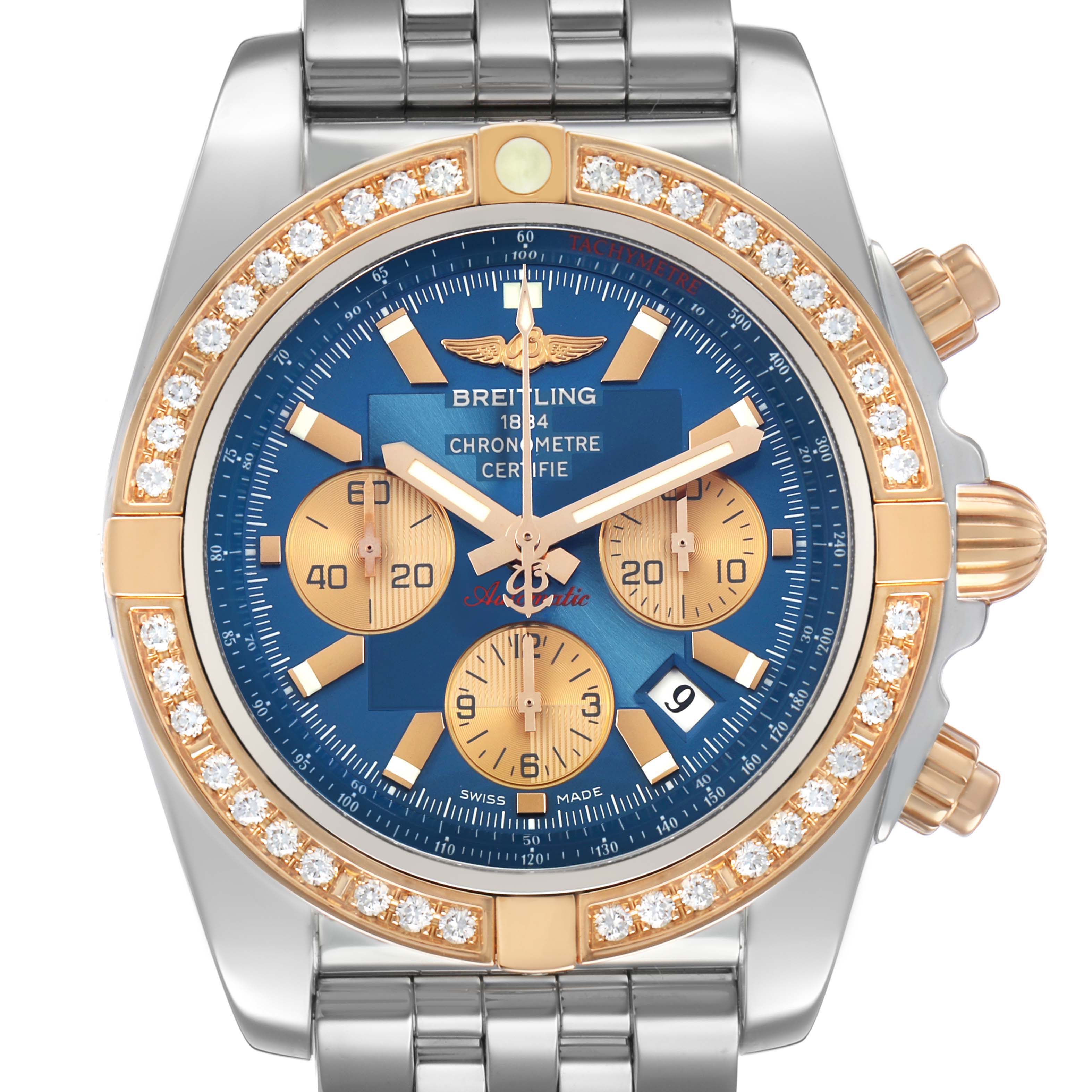 The Breitling Chronomat CB0110 Men's Steel and Gold (two tone) Blue Dial watch is shown from a top-down angle, highlighting its blue dial, gold subdials, diamond-set bezel, and metal bracelet.