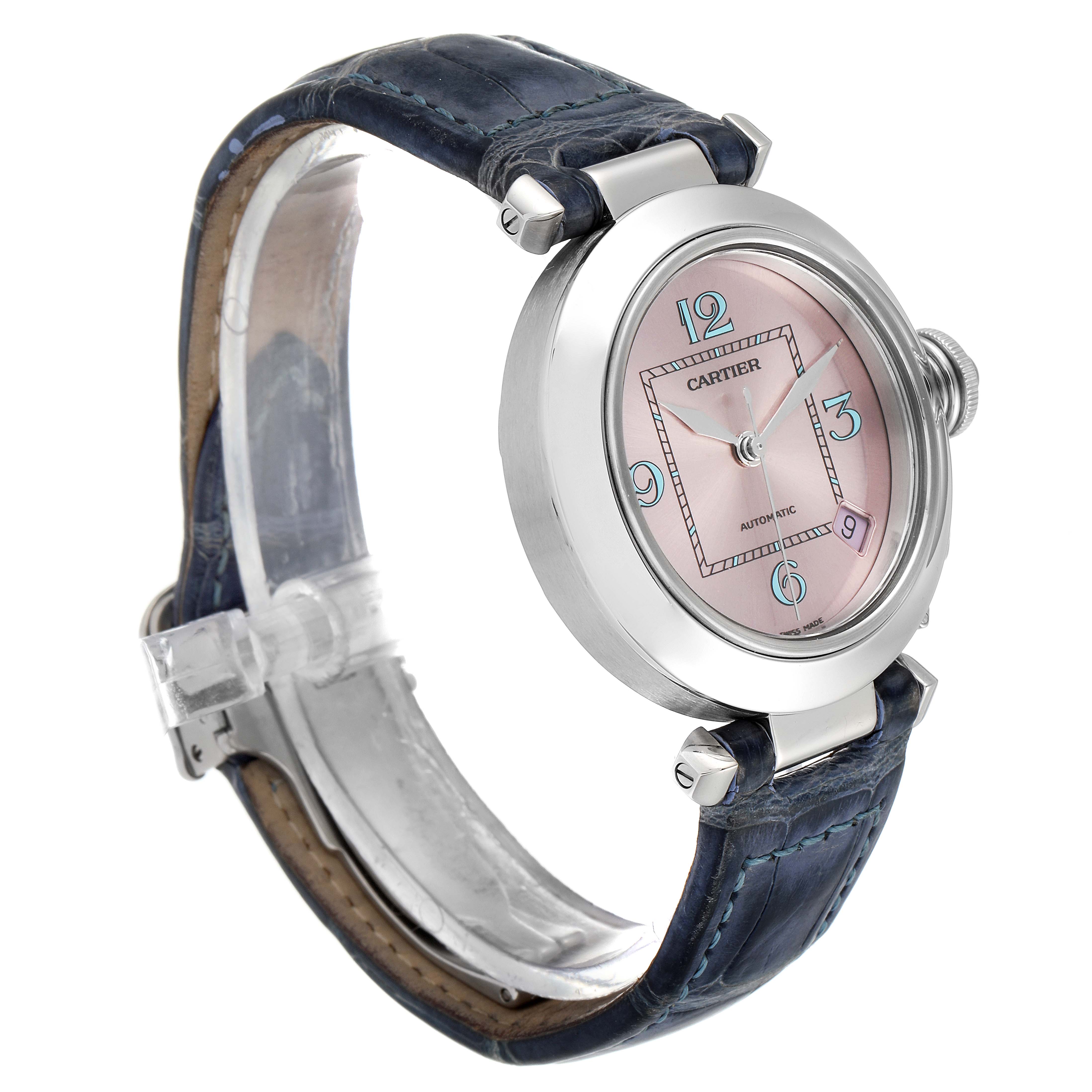 The image shows a side and front angle of the Cartier Pasha W3108199 Women's Stainless Steel Pink Dial W3108199 Women's Stainless Steel Pink Dial watch, highlighting its round face, pink dial, and blue leather strap.