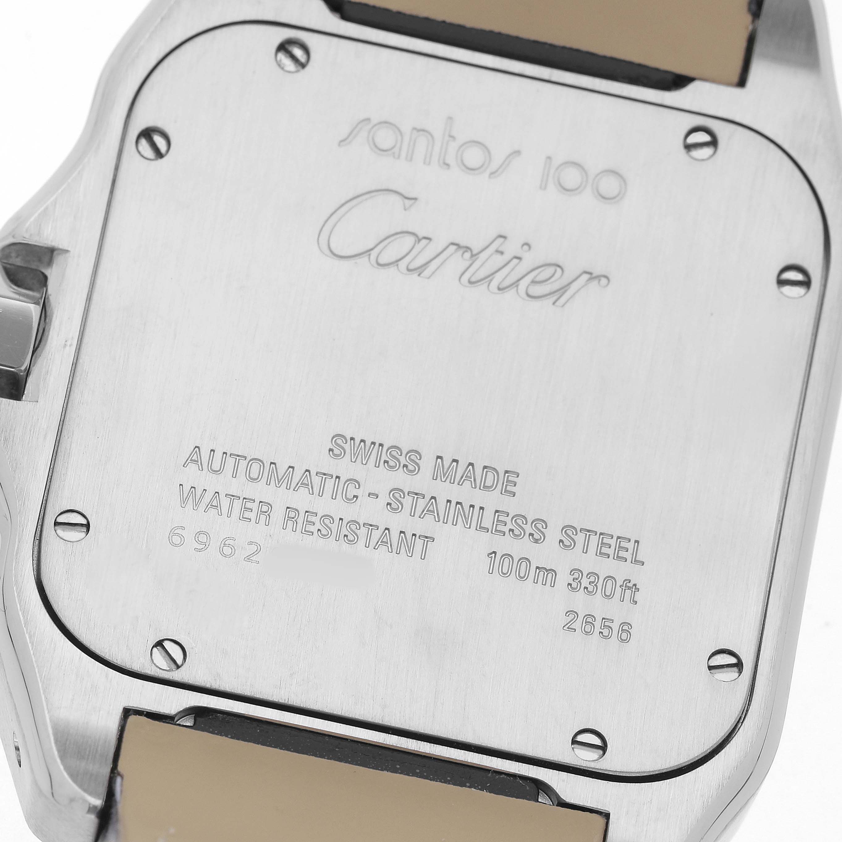 The image shows the back of a Cartier Santos W20073X8 Men's Stainless Steel Silver Dial 100 watch, highlighting details like the model, water resistance, and material.