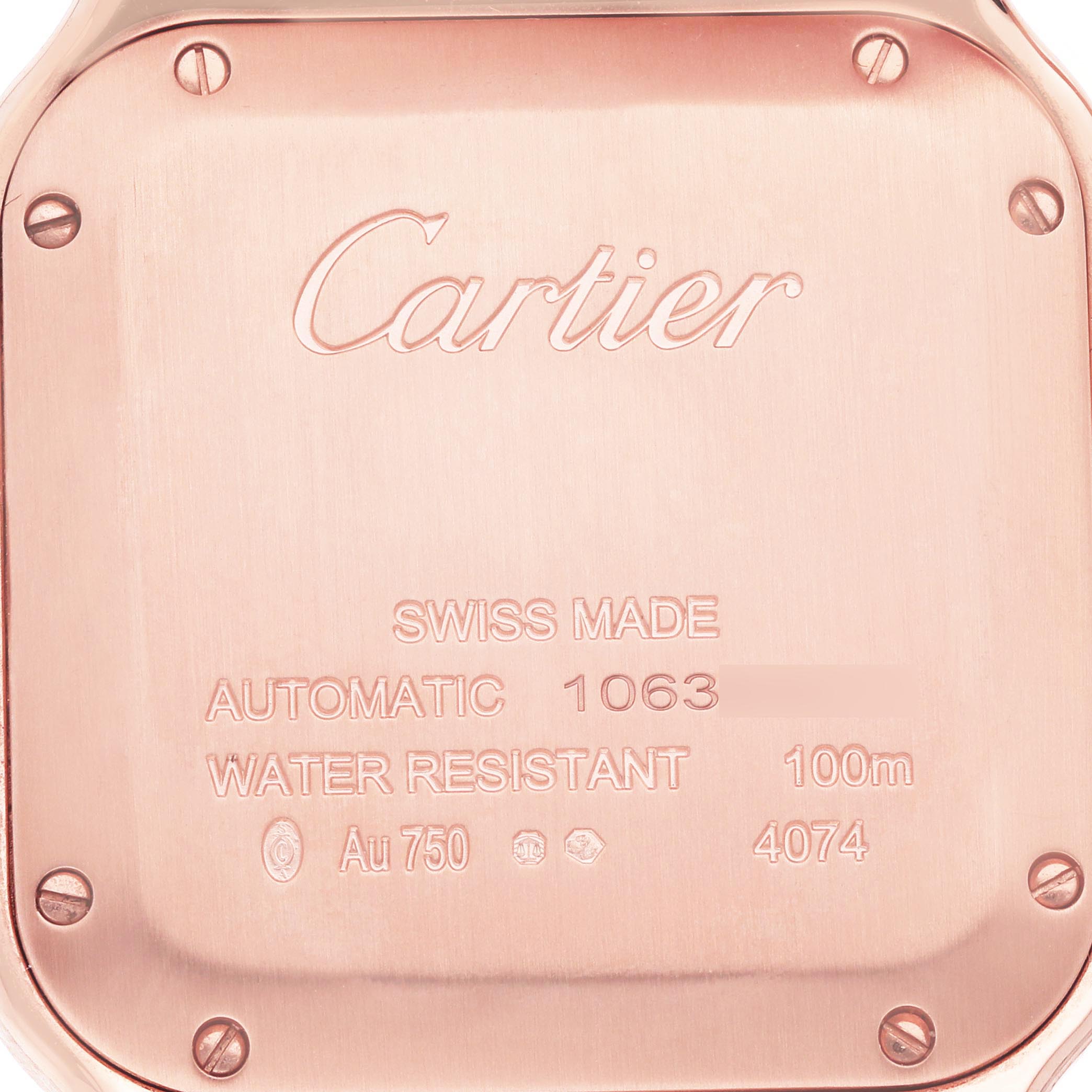 The image shows the back of a Cartier Santos WGSA0031 Men's Rose Gold Silver Dial WGSA0031 Men's Rose Gold Silver Dial watch, highlighting the engraved text and screws.