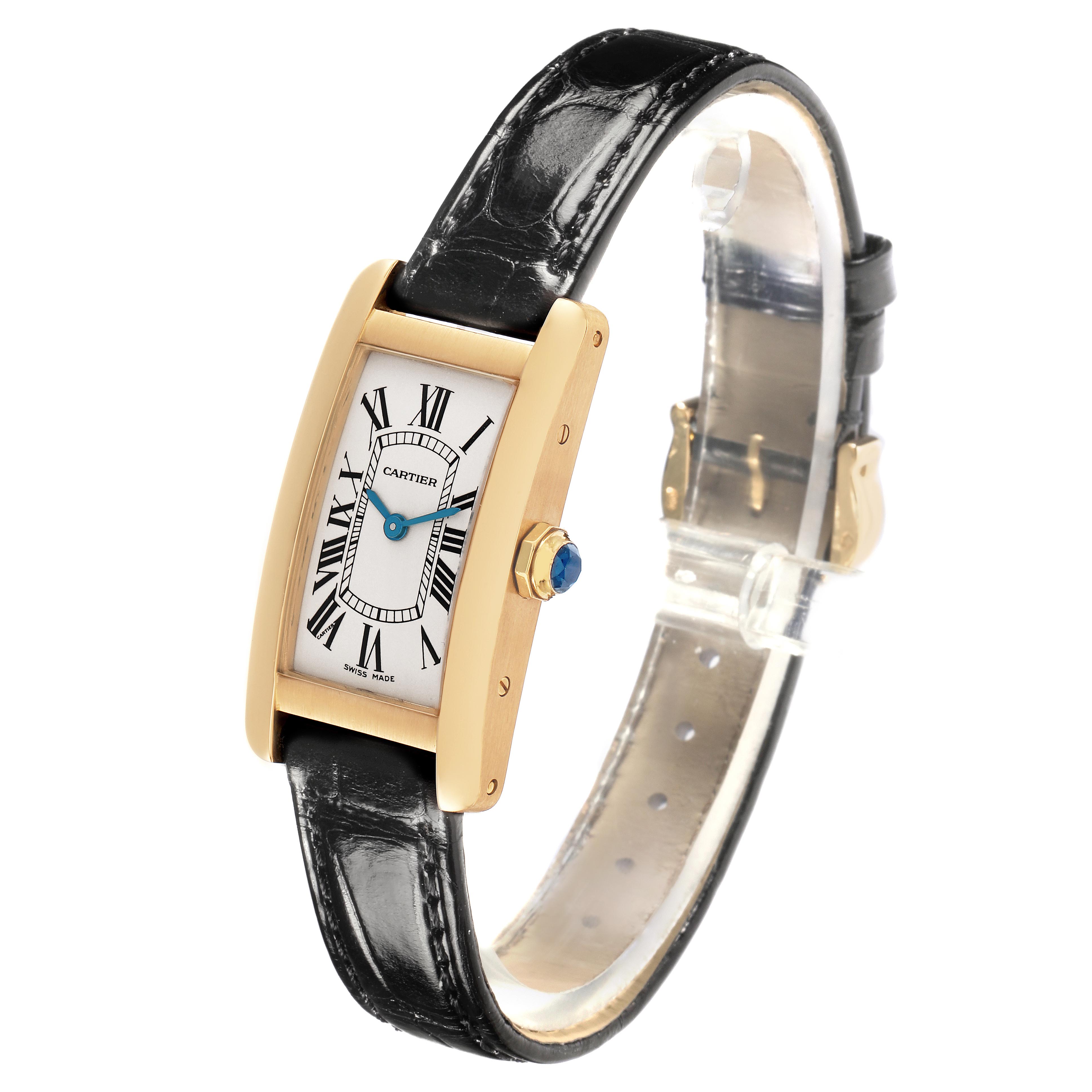 The Cartier Tank Americaine W2601556 Women's Yellow Gold Silver Dial W2601556 Women's Yellow Gold Silver Dial watch is shown at a slight side angle, highlighting its rectangular face, gold case, blue hands, and black leather strap.