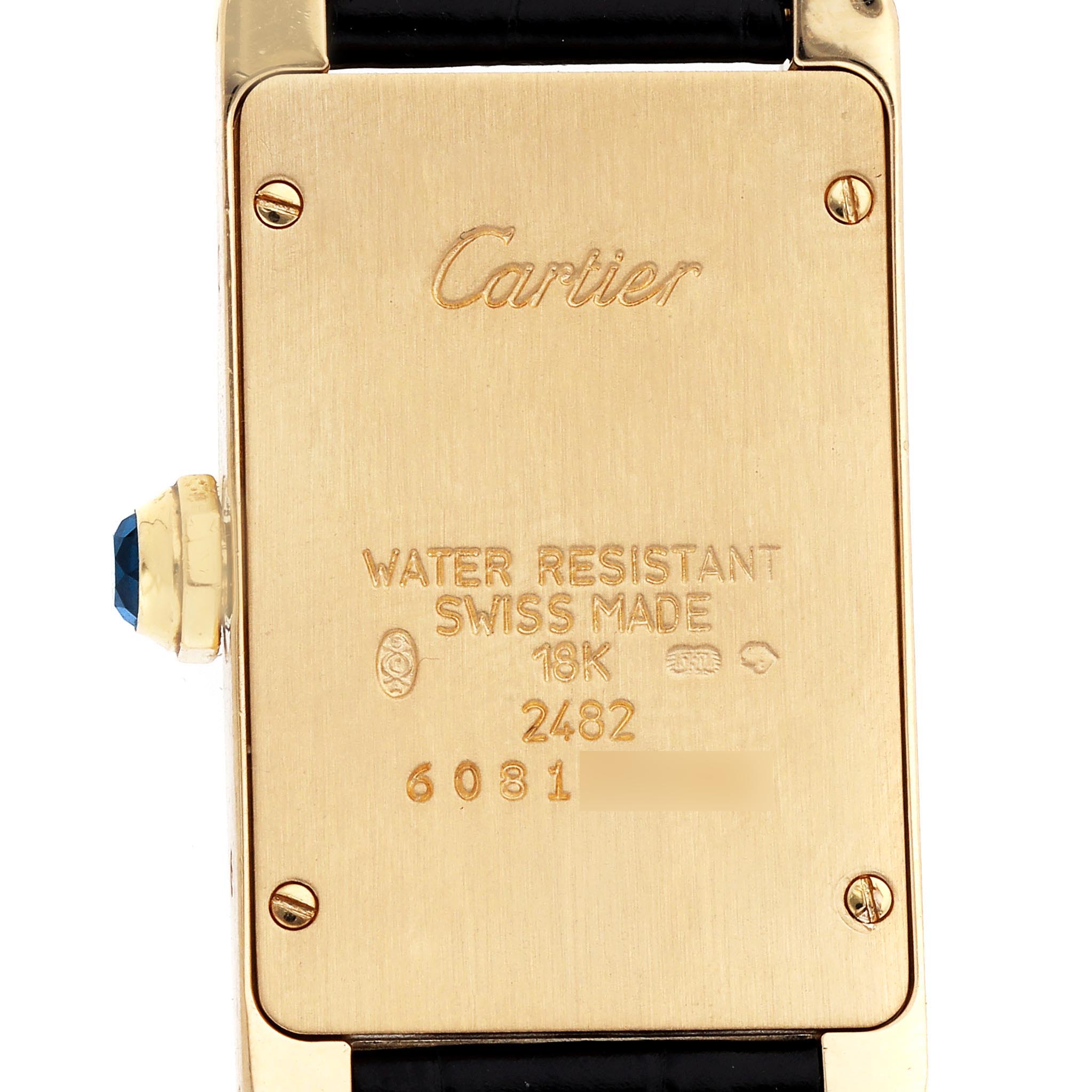 The image shows the back of the Cartier Tank Américaine watch, highlighting engravings and details.