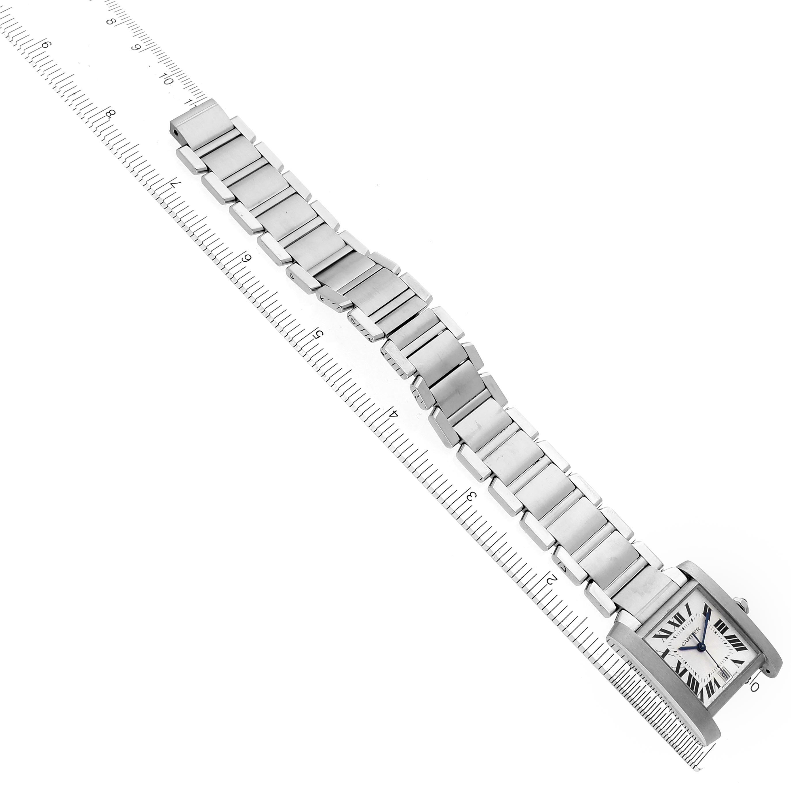 The Cartier Tank Francaise W51002Q3 Men
s Stainless Steel Silver Dial W51002Q3 Men
s Stainless Steel Silver Dial watch is shown at an angle highlighting the face, bracelet, and ruler for scale.