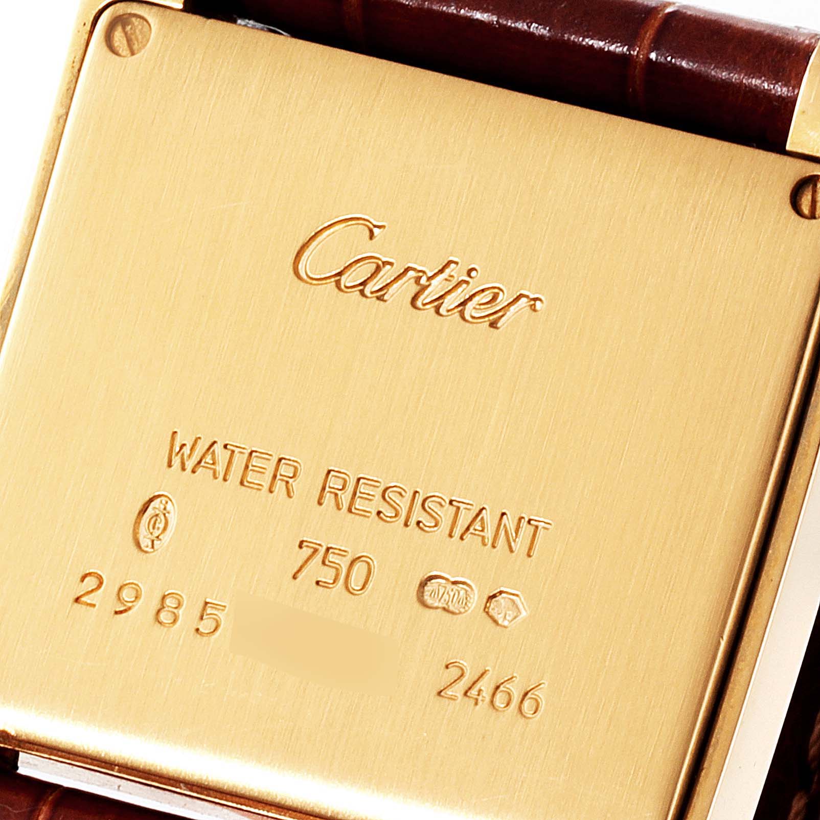 This image shows the back of a Cartier Tank Francaise W50014N2 Women
s Yellow Gold Silver Dial W50014N2 Women
s Yellow Gold Silver Dial watch, highlighting its water resistance and serial number.