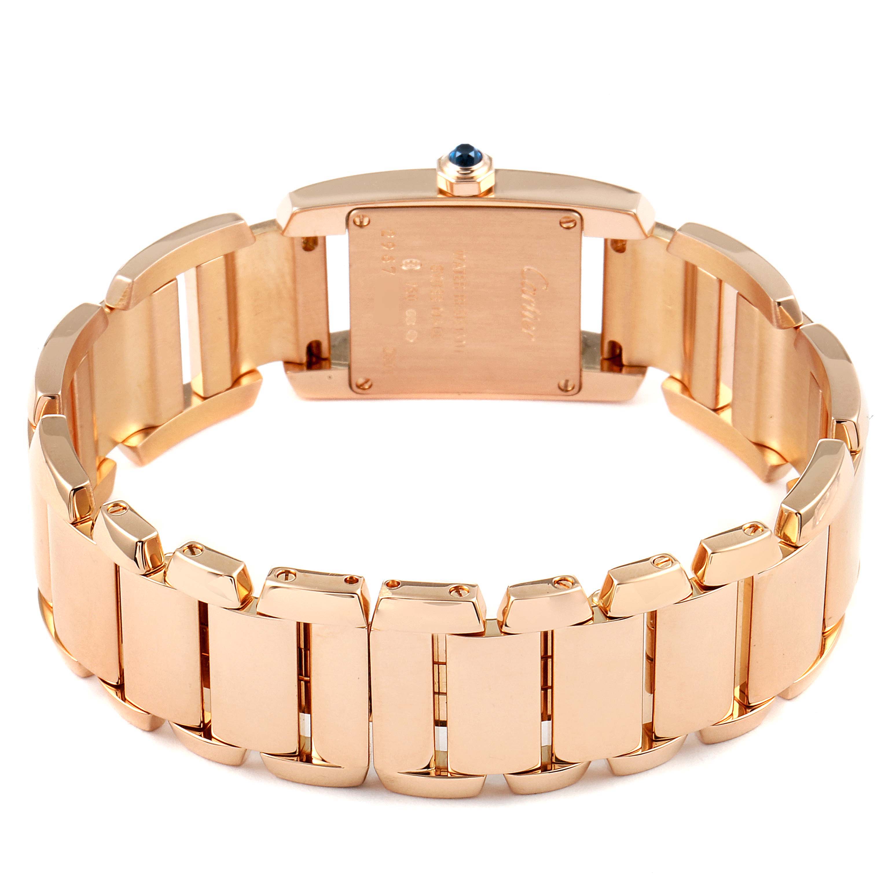 The image shows the rear view of a Cartier Tank Française watch, highlighting its gold bracelet and case back.