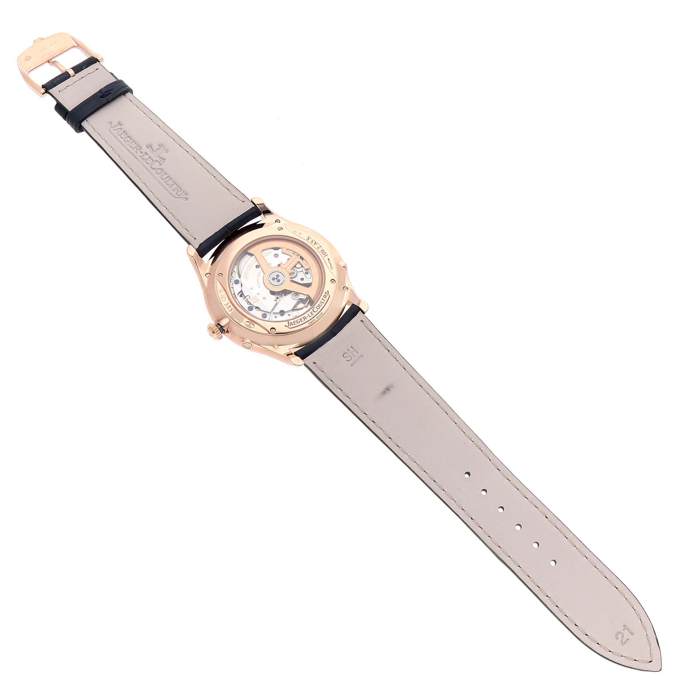 The image shows the back view of a Jaeger LeCoultre Master Q1362510 Men's Rose Gold Beige Dial model, highlighting its open caseback and leather strap.