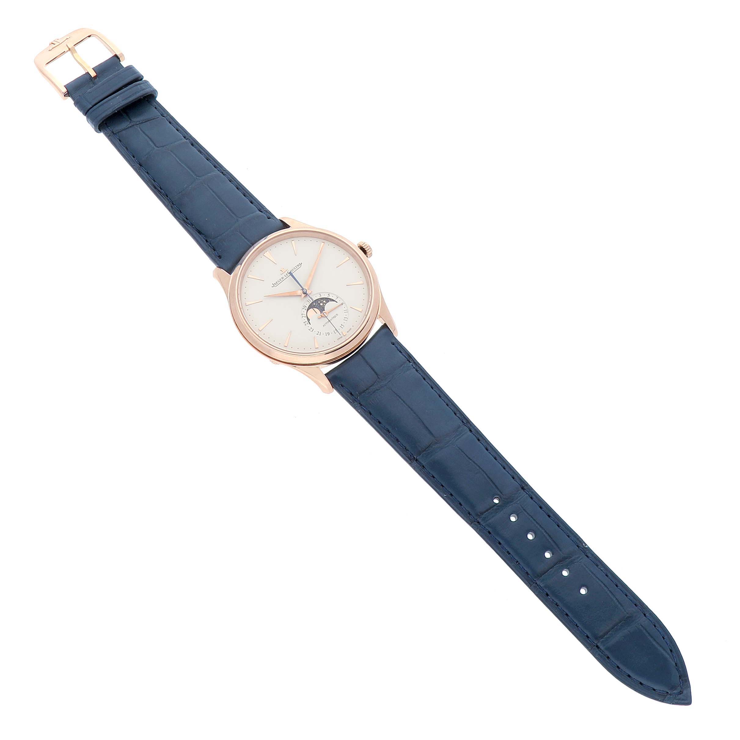 The Jaeger LeCoultre Master Q1362510 Men's Rose Gold Beige Dial watch is shown from an angled top view, highlighting its face, blue strap, and buckle.