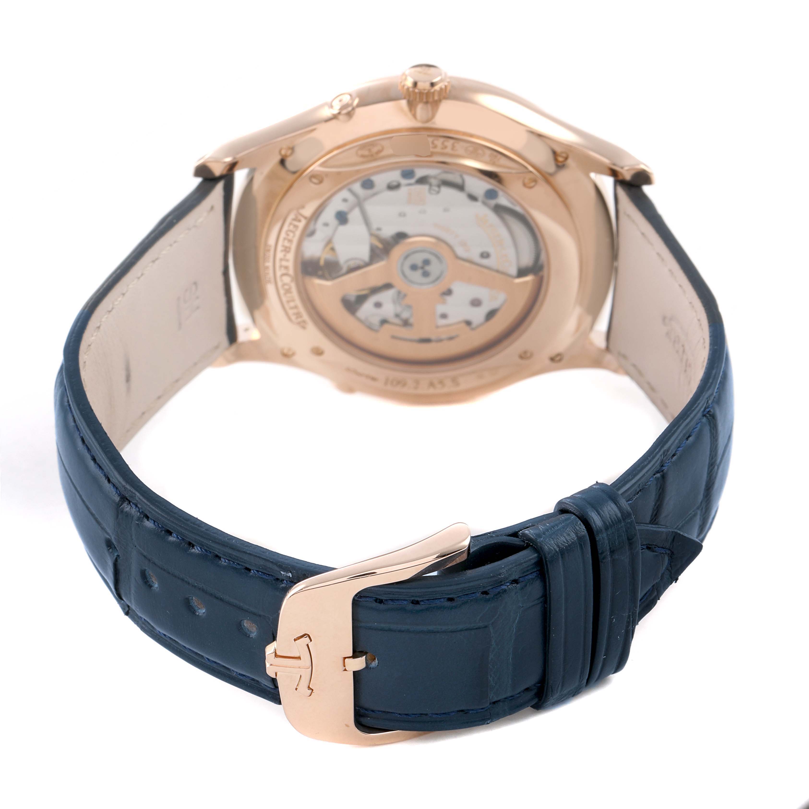 The image shows the back of a Jaeger LeCoultre Master Q1362510 Men's Rose Gold Beige Dial model, highlighting its open case back and blue leather strap.