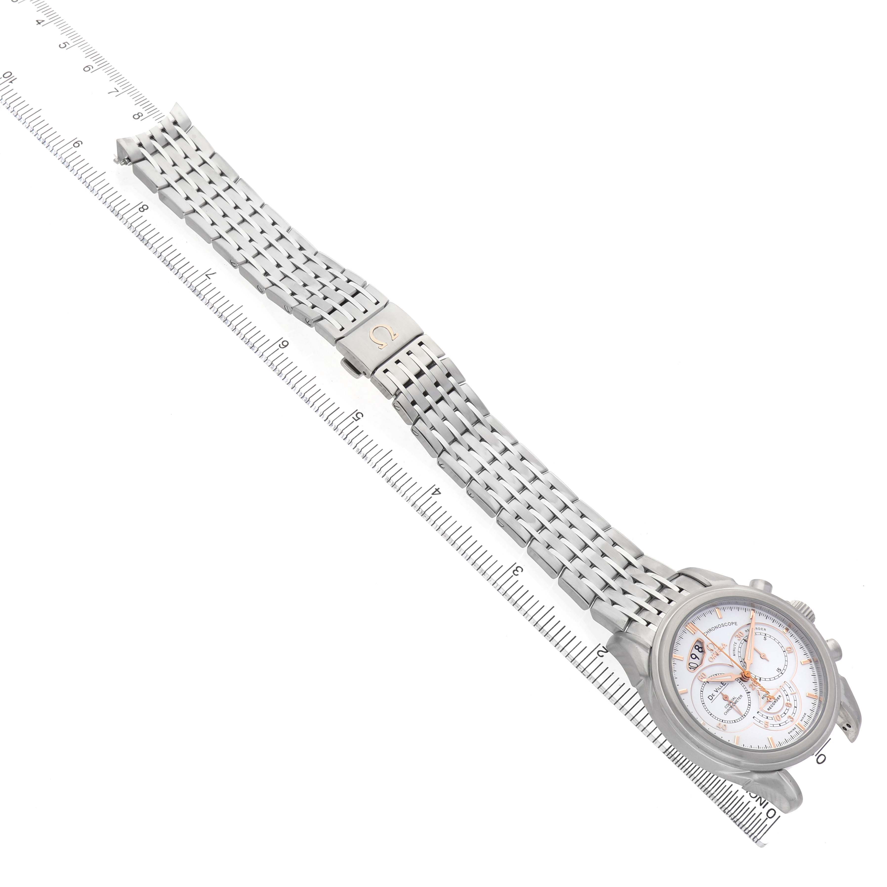 The Omega De Ville 422.10.41.50.04.001 Men's Stainless Steel White Dial watch is shown from an overhead angle, displaying the full bracelet and face alongside a ruler for scale.