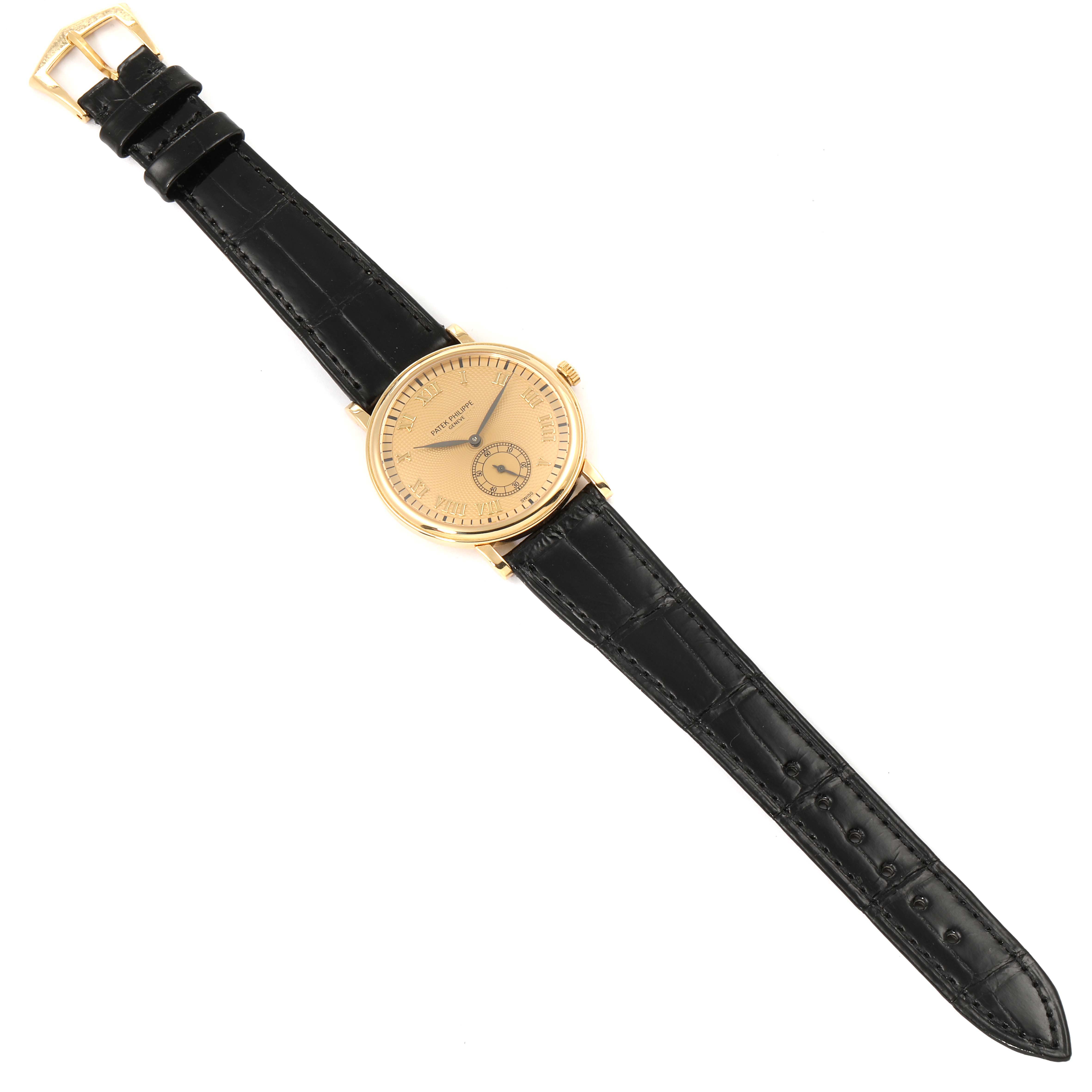 The image shows a top-down view of a Patek Philippe Calatrava 5022R Men's Rose Gold Pink Dial 5022R Men's Rose Gold Pink Dial watch, displaying its black leather strap and gold dial.