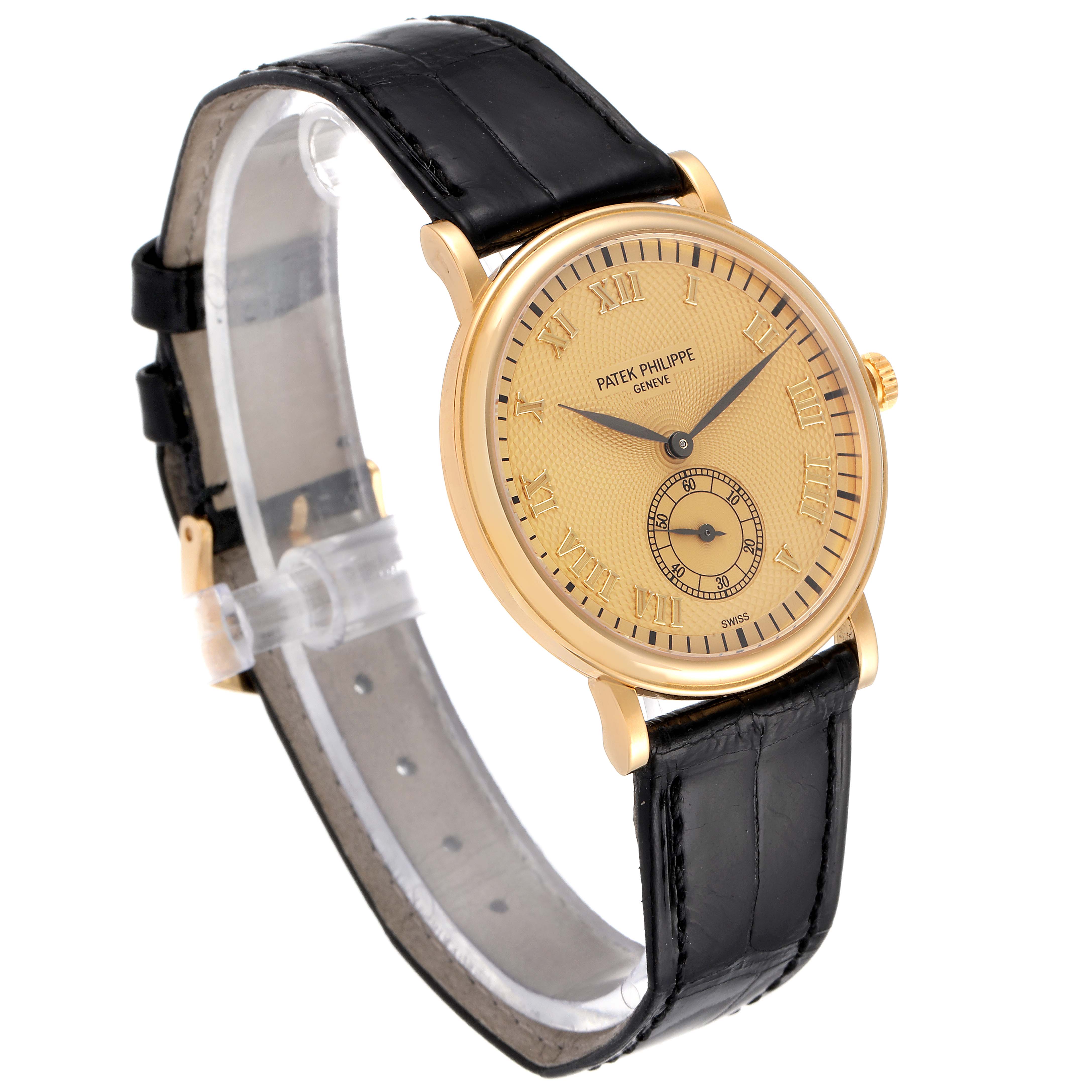 This image shows a Patek Philippe Calatrava 5022R Men's Rose Gold Pink Dial 5022R Men's Rose Gold Pink Dial model watch at an oblique angle, highlighting its black leather strap and gold casing.