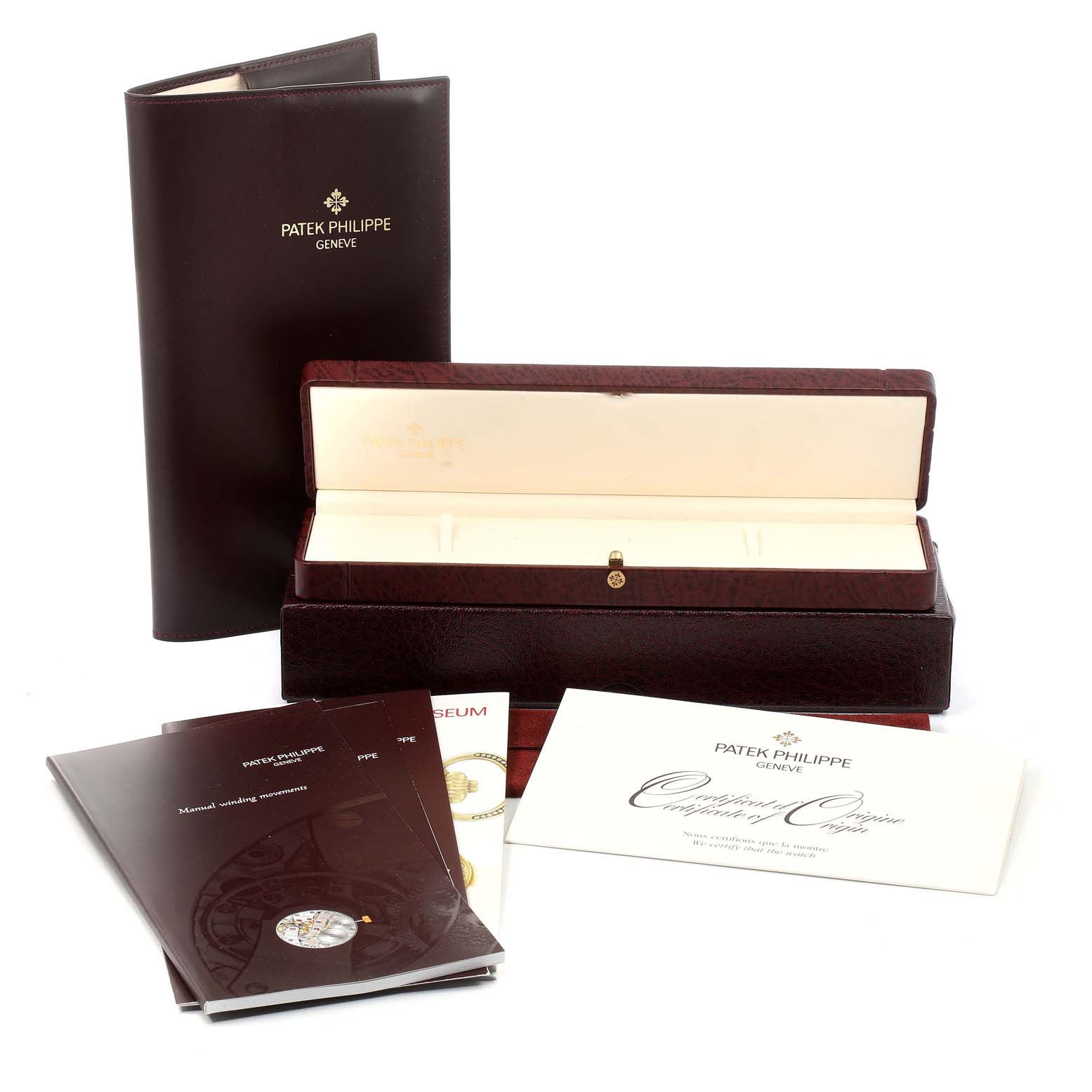 The image shows the accessories of a Patek Philippe Calatrava 5022R Men's Rose Gold Pink Dial 5022R Men's Rose Gold Pink Dial watch, including its case, booklets, and certificate.